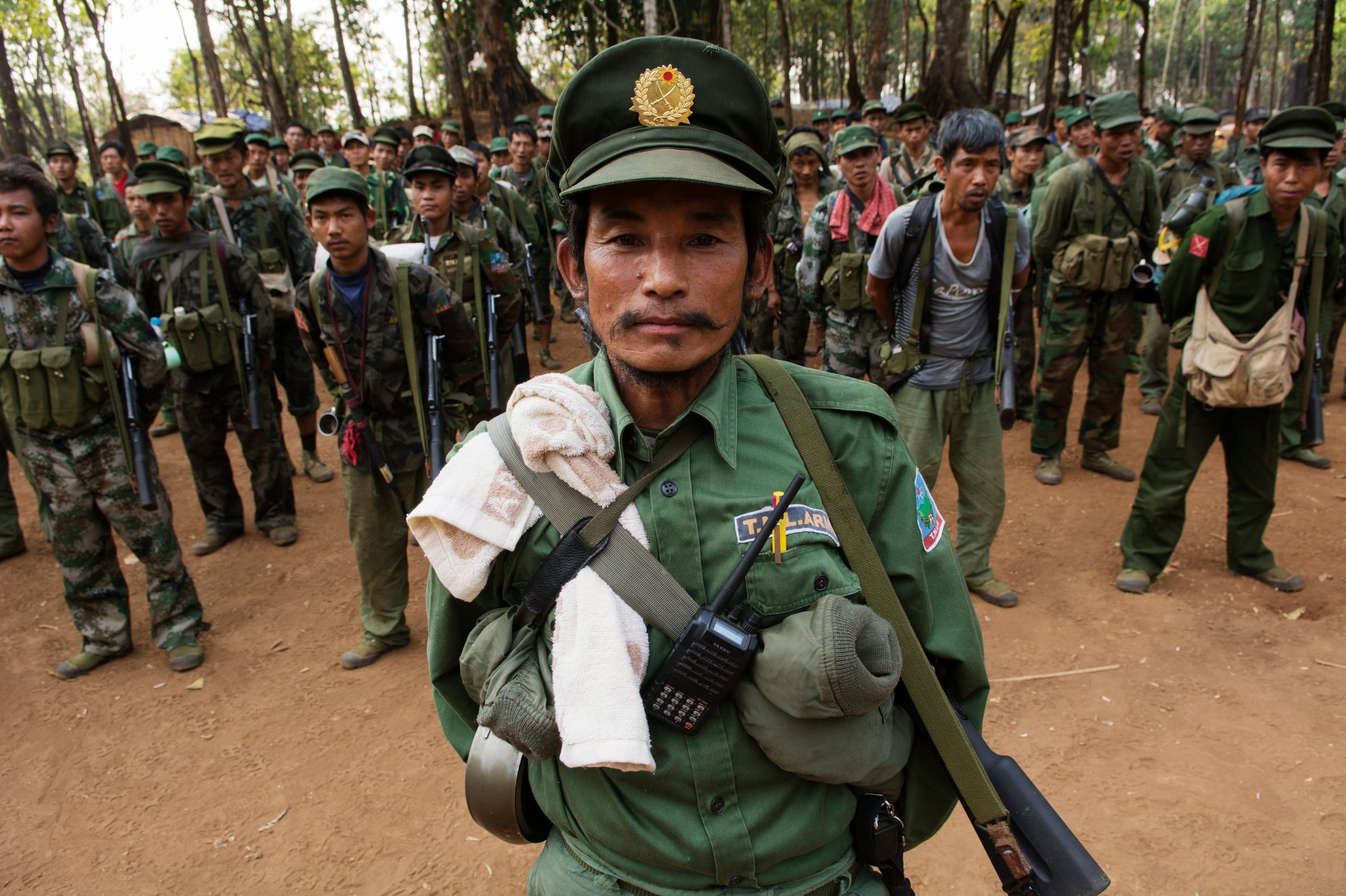 SHAN STATE, MYANMAR - 2014/03/12: An officer from the TNLA (Ta'ang National Liberation Army, Ta'ang is another word for Palaung) stands at attention with his soldiers during a morning gathering in a military camp.The TNLA, created in 2009, claims about 1,500 soldiers and another 1,500 trained villagers. Alongside with other ethnic groups, the TNLA fights the government troops in order to get some kind of autonomy within a federal system for the Palaung populated area in north-west Shan State. (Photo by Thierry Falise/LightRocket via Getty Images)