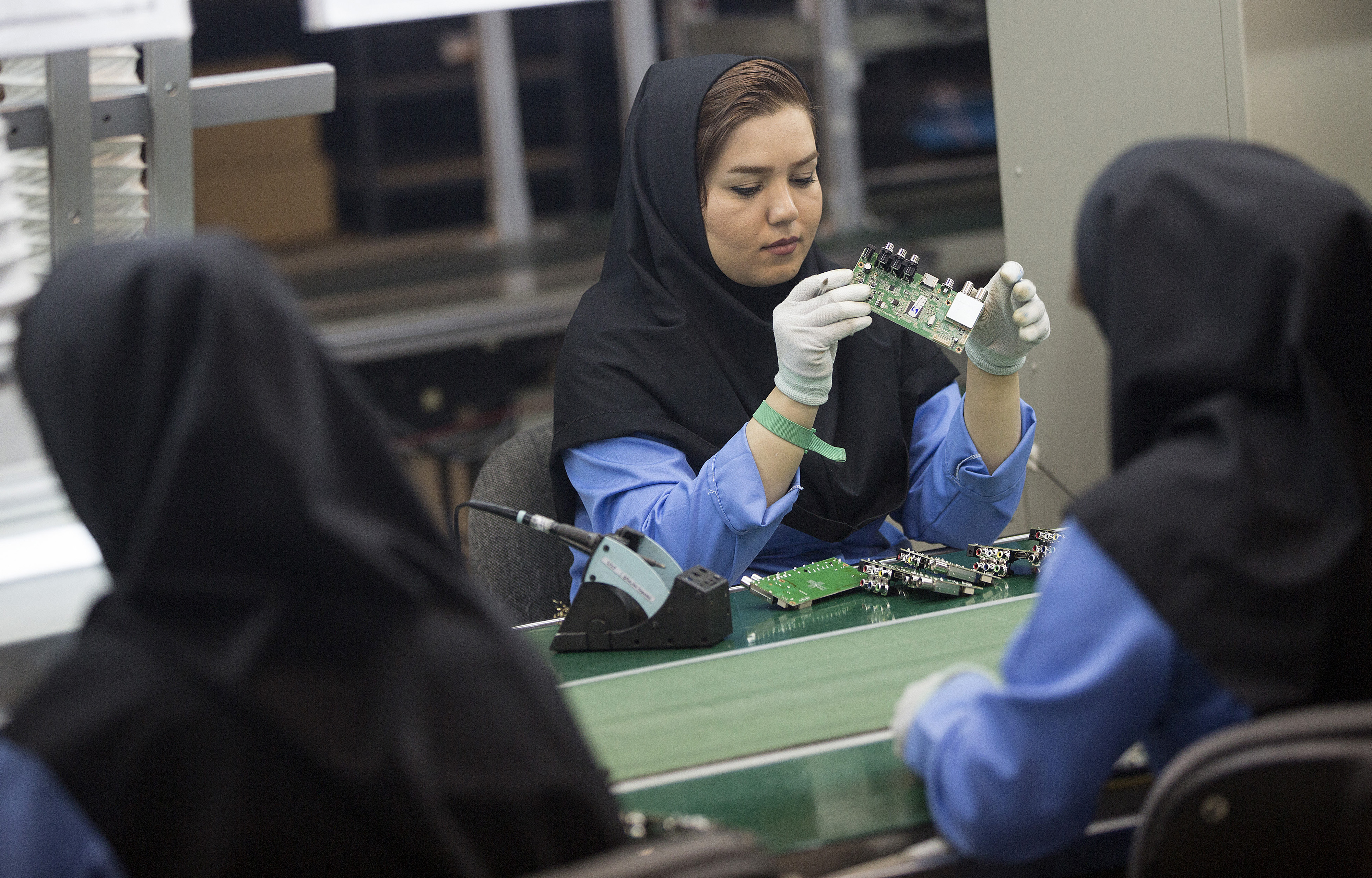 Female employees work on the assembly of electronic circuit boards at the Maadiran Group electronics distribution and manufacturing plant in Hashtgerd, Iran, on Tuesday, Sept. 1, 2015. (Simon Dawson—2015 Bloomberg Finance LP)