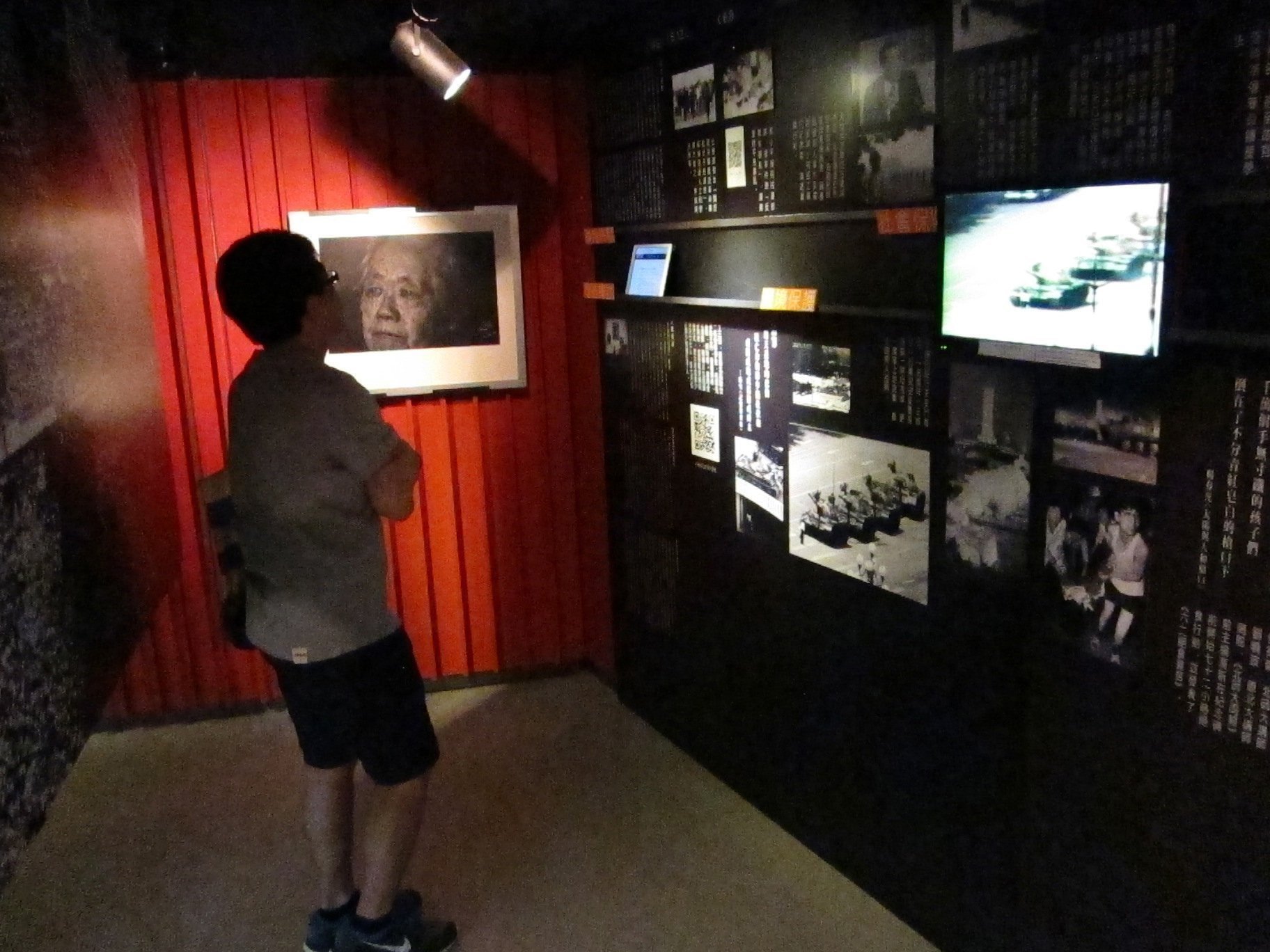 A visitor to the June 4 Memorial Hall in Hong Kong watches a video of Chinese tanks rolling into Beijing's Tiananman Square during the 1989 crackdown on pro-democracy protesters on May 23, 2014 (MCT/Getty Images)