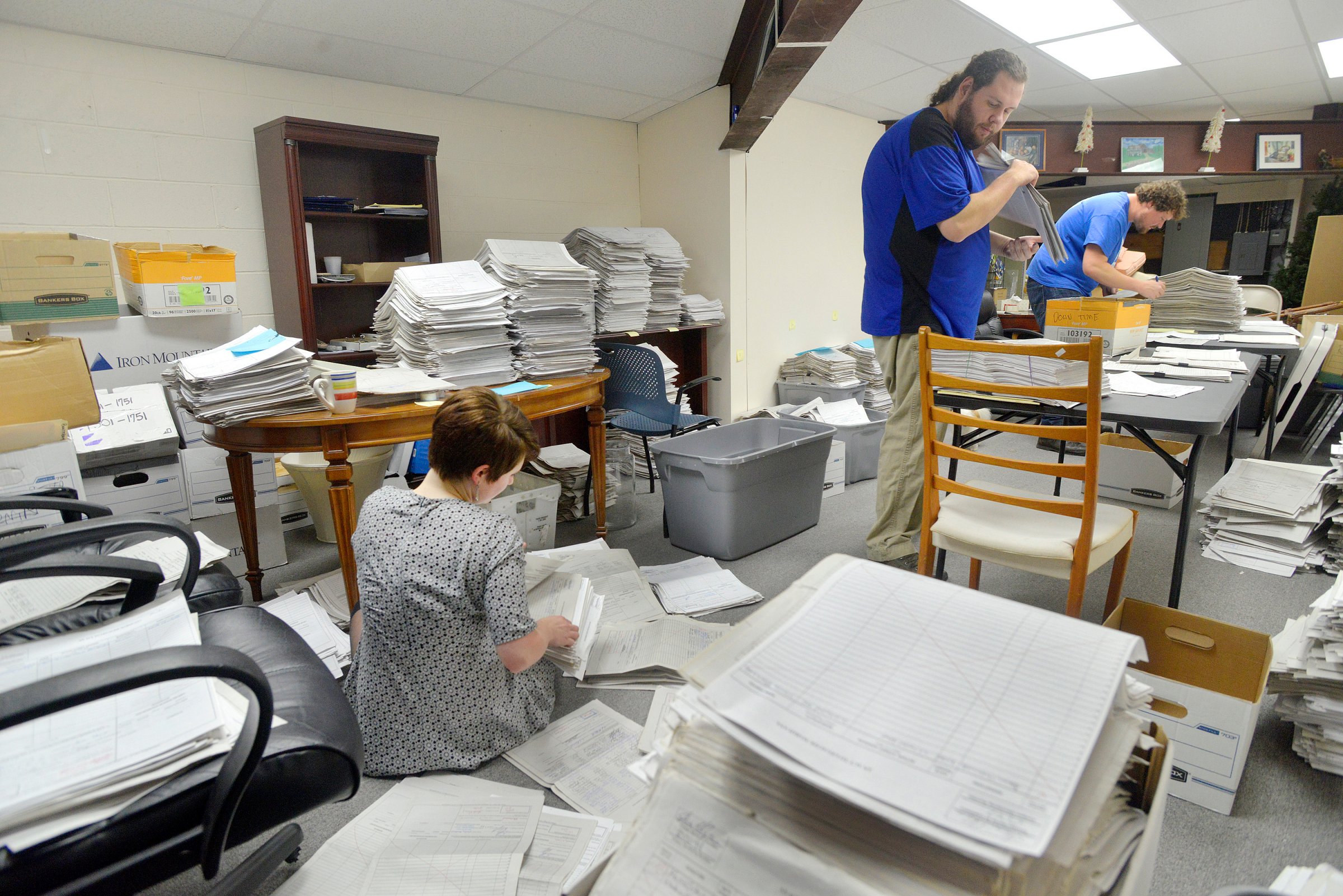 FALMOUTH, ME - JANUARY 26: Staff and volunteers  for the marijuana legalization campaign are sorting petitions at their office in Falmouth. Volunteer Allison Cormier (left) along with office manager Shaun Bowen (center) and field director Jordan DeCoster sort and organize stacks of petitions at their campaign headquarters. (Photo by John Ewing/Staff Photographer)