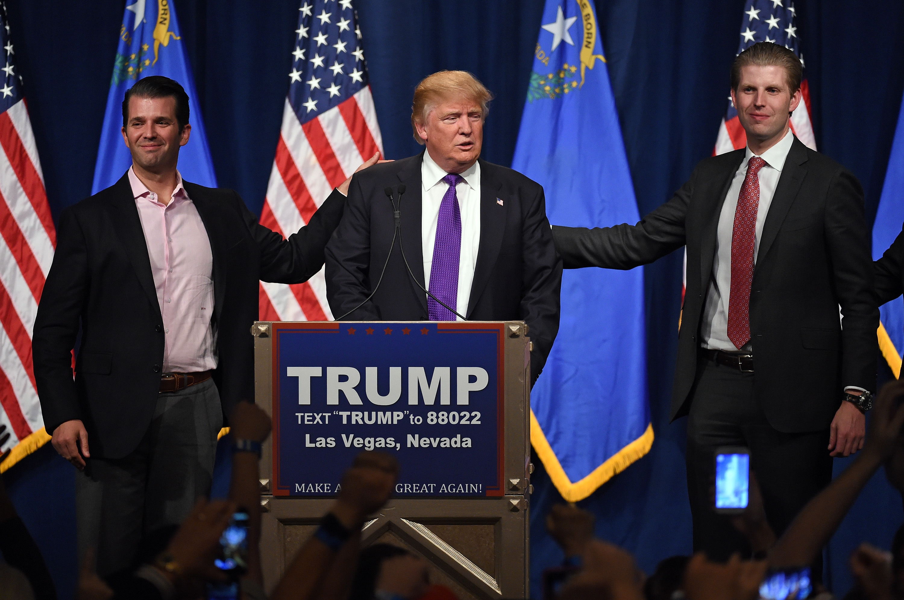 Republican presidential candidate Donald Trump (C) speaks as his sons Donald Trump Jr. (L) and Eric Trump (R) look on during a caucus night watch party at the Treasure Island Hotel &amp; Casino on February 23, 2016 in Las Vegas, Nevada. The New York businessman won his third state victory in a row in the "first in the West" caucuses. (Ethan Miller—Getty Images)