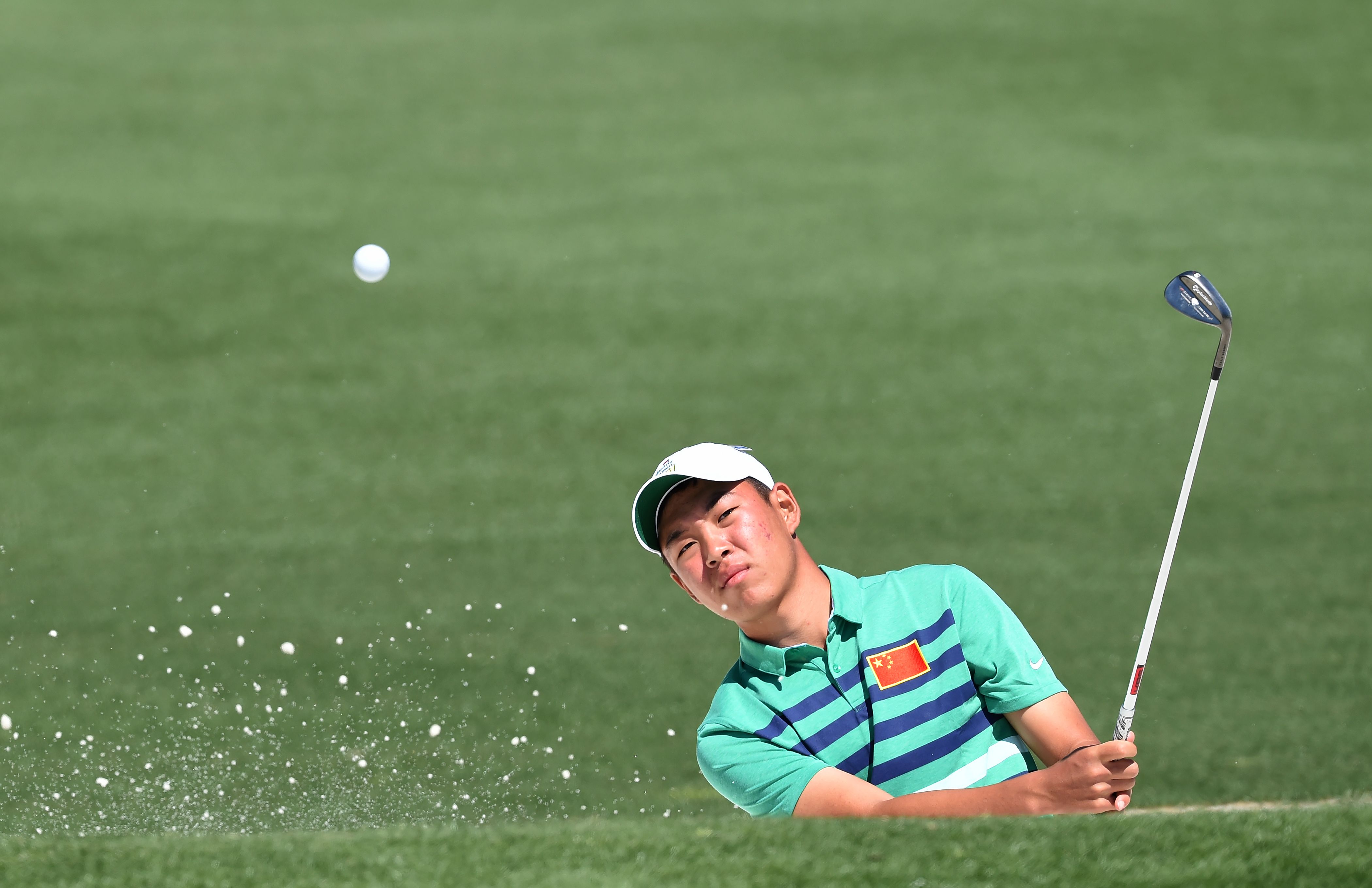 China's Jin Cheng hits out of a bunker during a practice round prior to the start of the 80th Masters Golf Tournament at the Augusta National Golf Club in Augusta, Ga., on April 5, 2016 (Don Emmert—AFP/Getty Images)