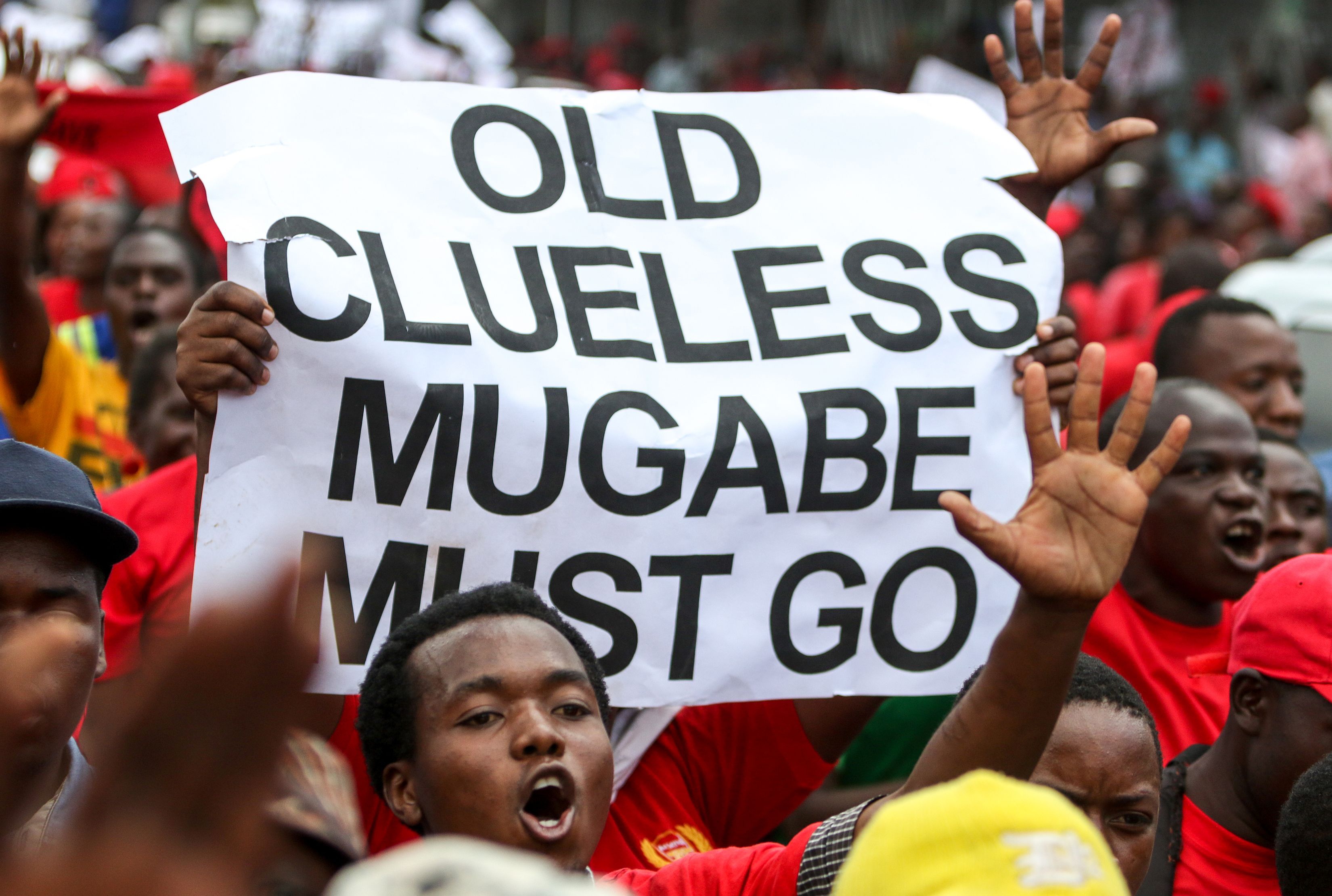 Movement for Democratic Change (MDC) youth supporters hold up a sign during a demonstration by the opposition party in Harare on April 14, 2016 (Jekesai Njikizana—AFP/Getty Images)