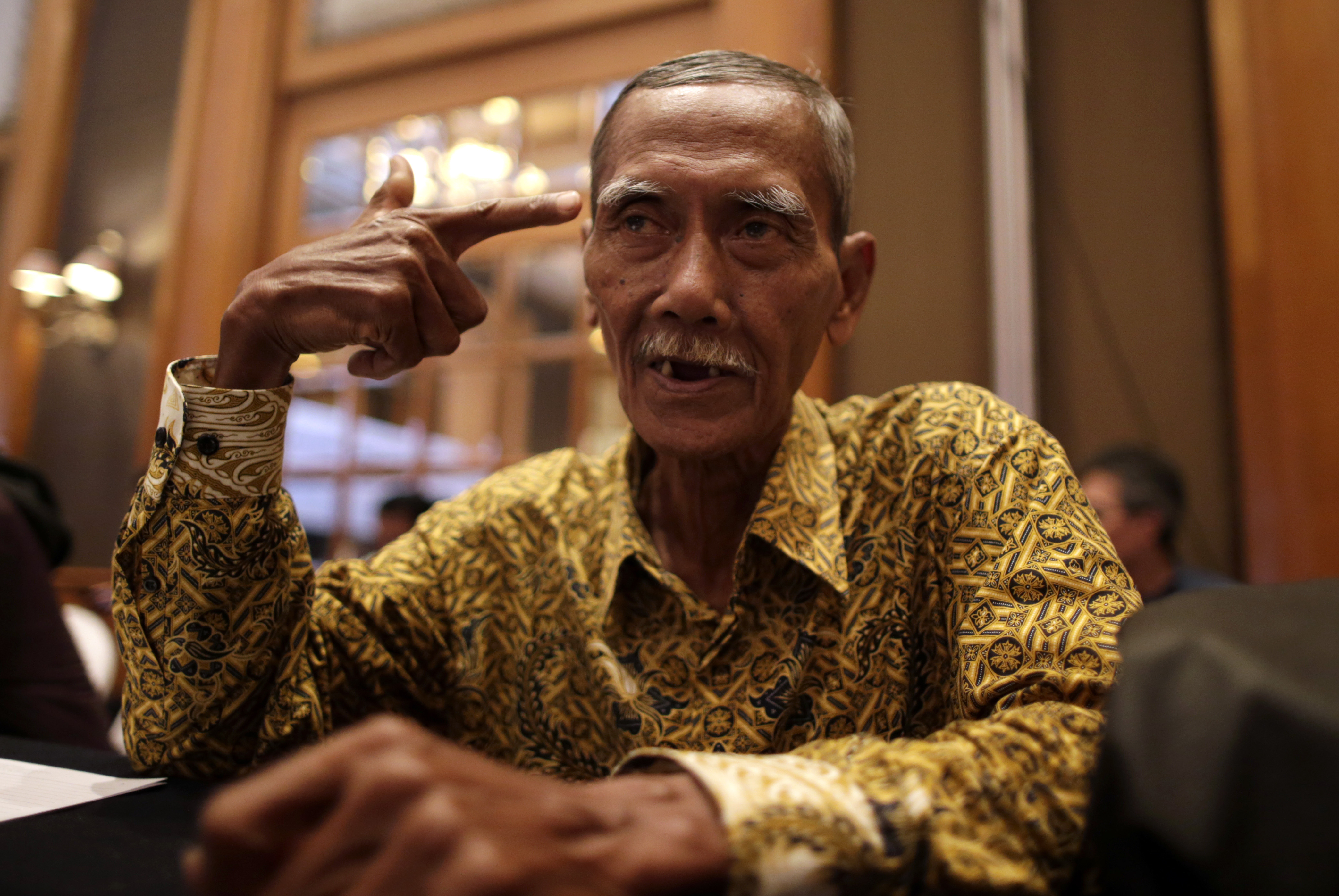 Komara, 67, who spent 100 days imprisoned without trial during the Indonesian government's anticommunist purge in 1965–66, tells his story on the sideline of a symposium on April 18, 2016 in Jakarta (Mast Irham—EPA)