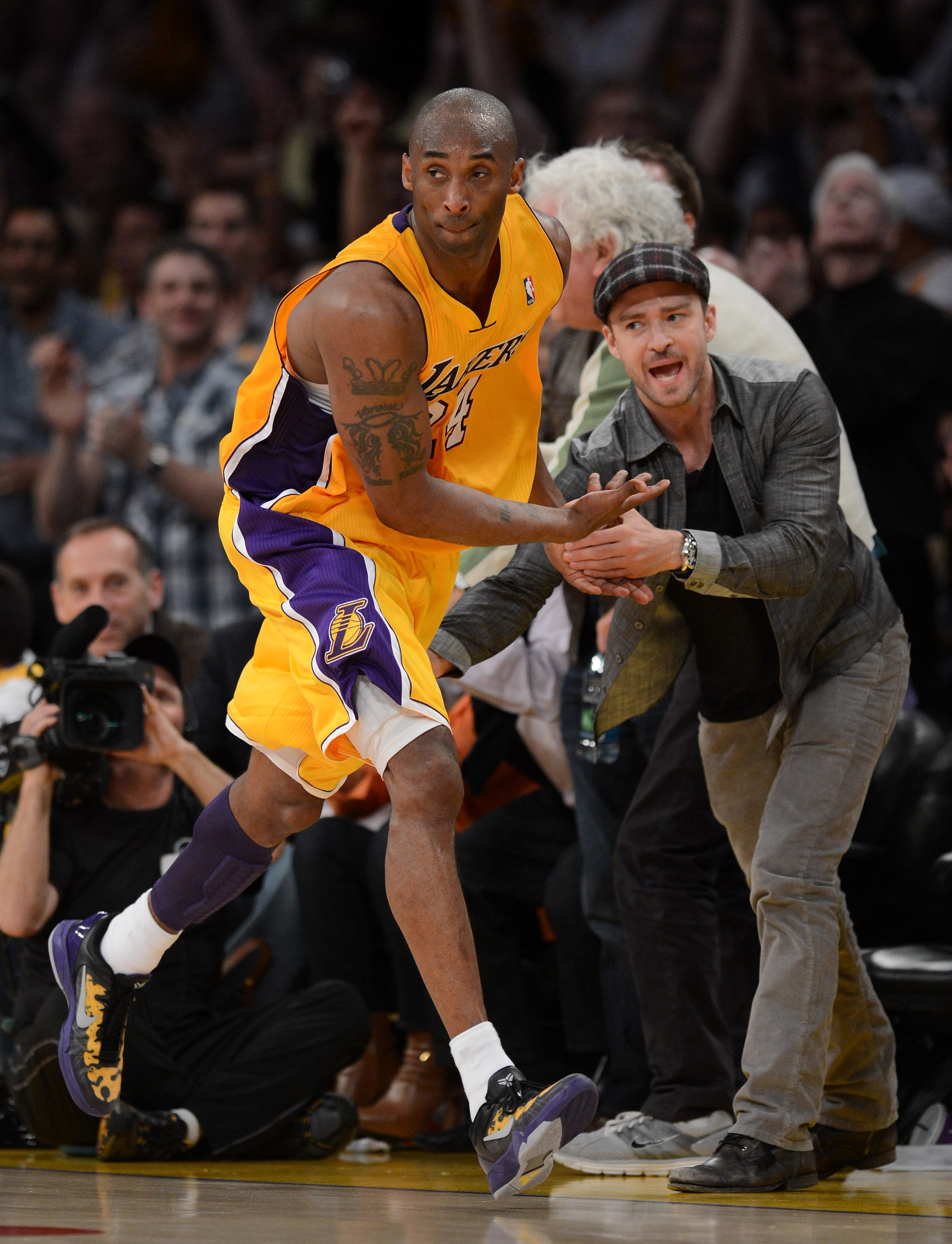 Los Angeles Lakers' Kobe Bryant (24) is greeted by Justin Timberlake after scoring during Game 7 of a 2012 NBA basketball playoff game against the Denver Nuggets on May 12, 2012 at Staples Center in Los Angeles.