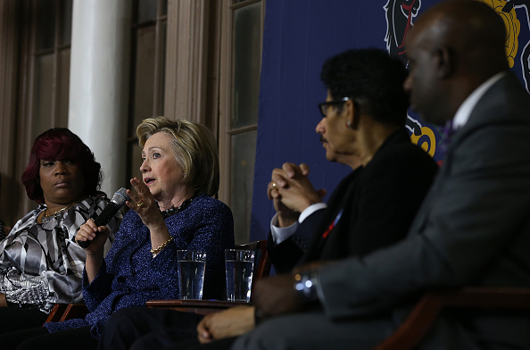 Democratic presidential candidate former Secretary of State Hillary Clinton (L) speaks during a panel discussion on gun violence at St. Paul's Baptist Church on April 20, 2016 in Philadelphia, Pennsylvania.