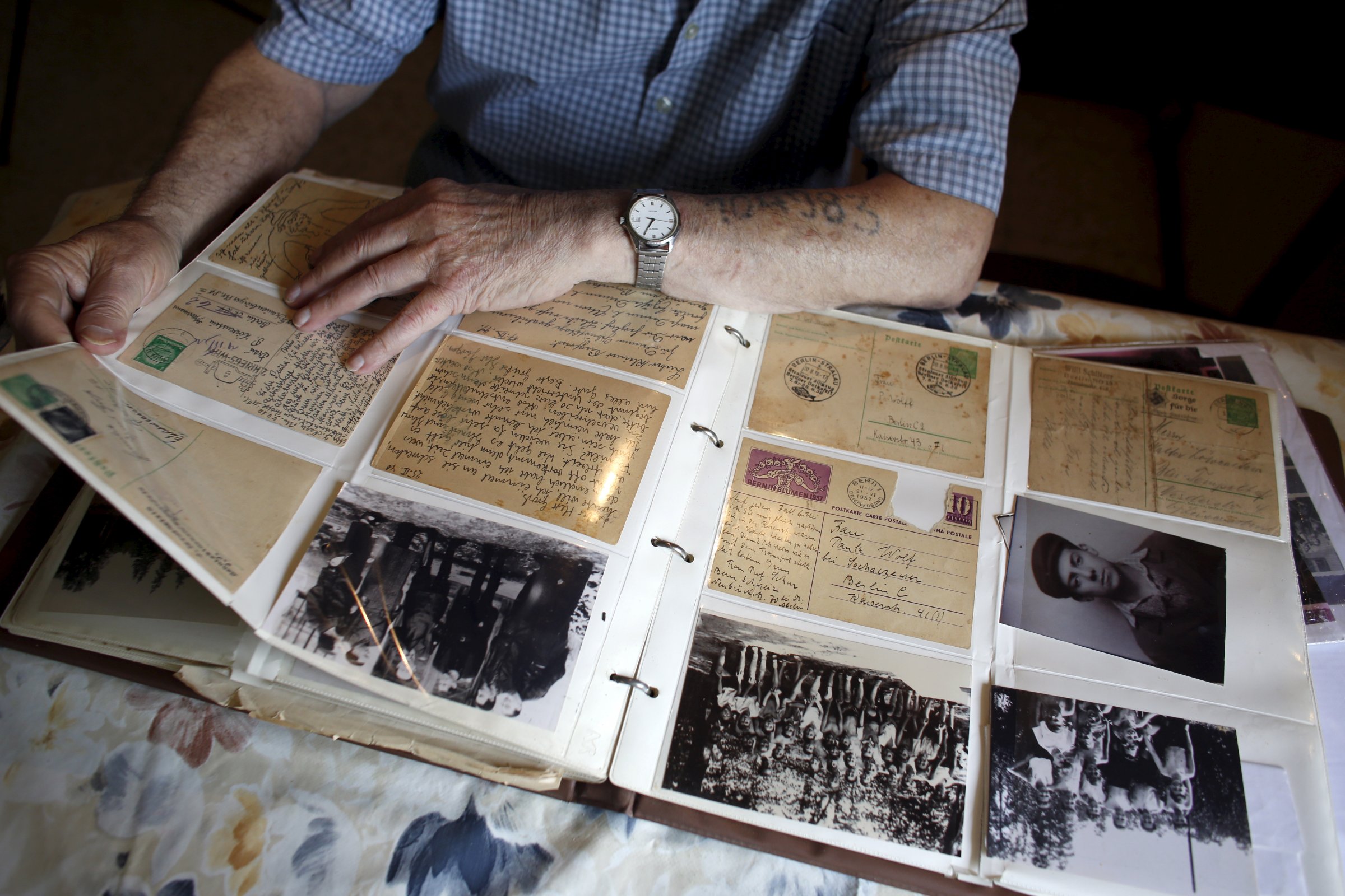 Holocaust survivor Israel Loewenstein, 91, looks at a photo album at his home in Yad Hana, Israel on April 6, 2016.