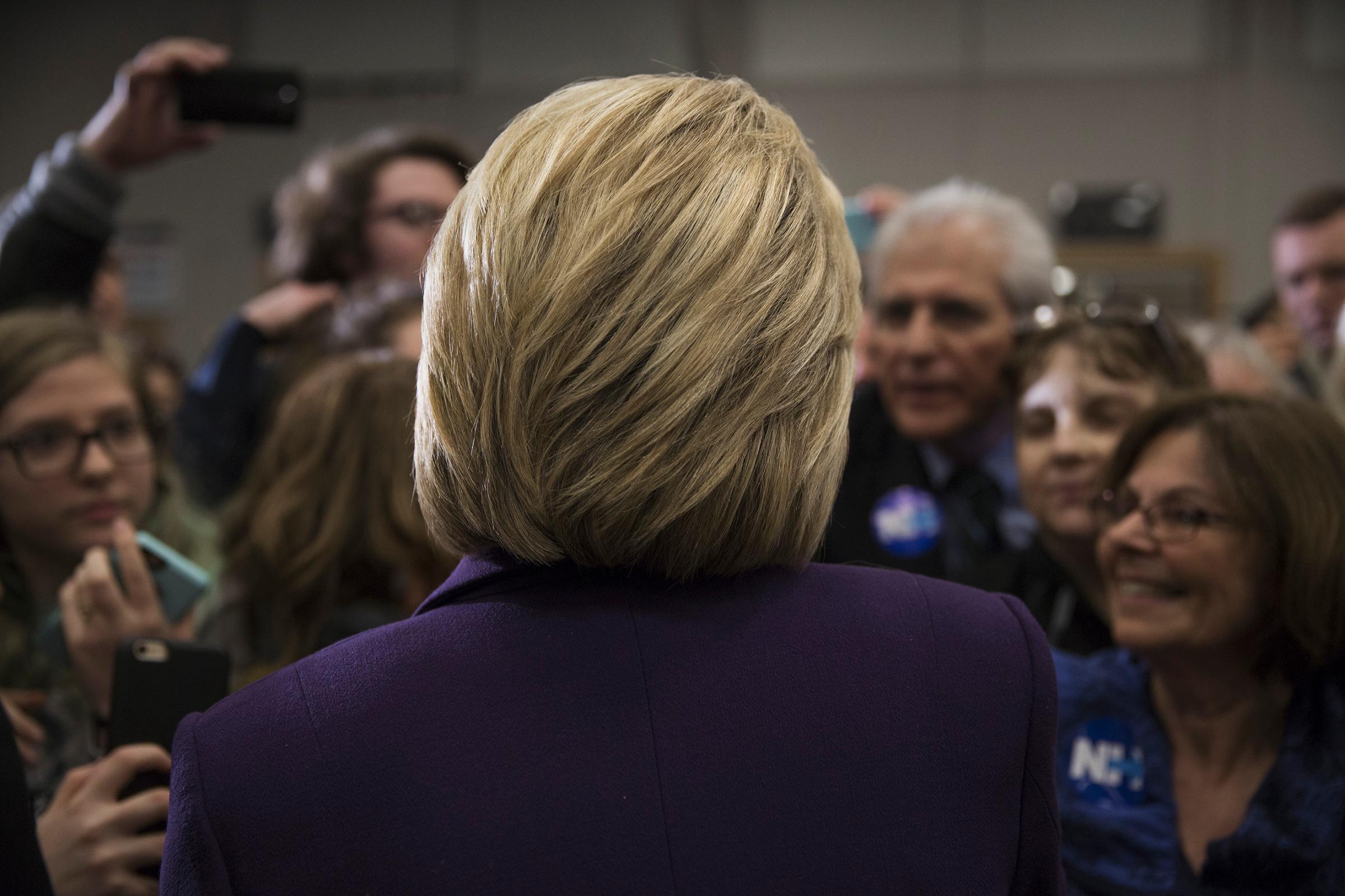 Hillary Clinton campaigning in New Hampshire presidential primary. Winnacunnet High School, Hampton, NH. Being interviewed by Joe Klein of TIME Magazine.by James Nachtwey