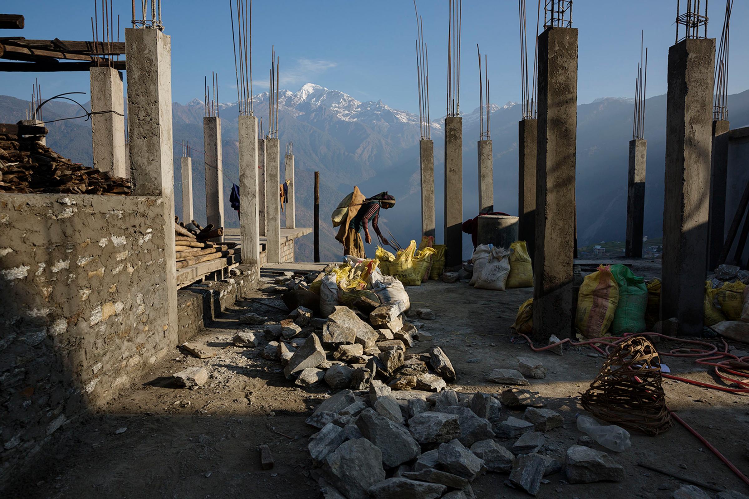 Villagers rebuild houses and pathways in the village of Barpak, in Gorkha district, Nepal, at the epicenter of the April and May 2015 earthquakes which killed 9000 people, April 6, 2016.