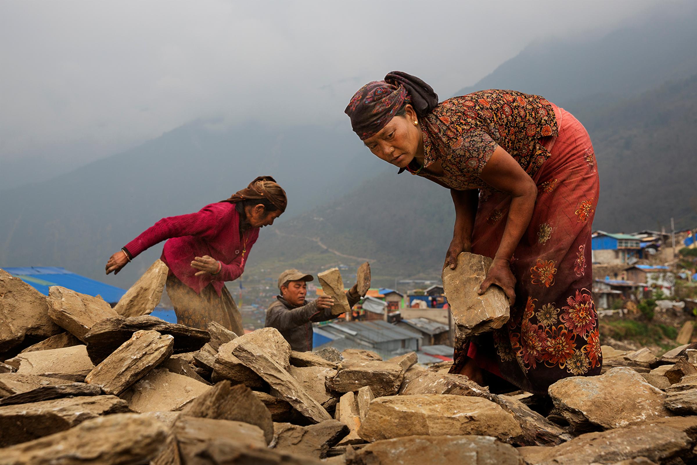 Nearly a year after Nepal's earthquakes of 2015, villagers work at rebuilding with little or no government support, Barpak, Nepal, April 3, 2016.