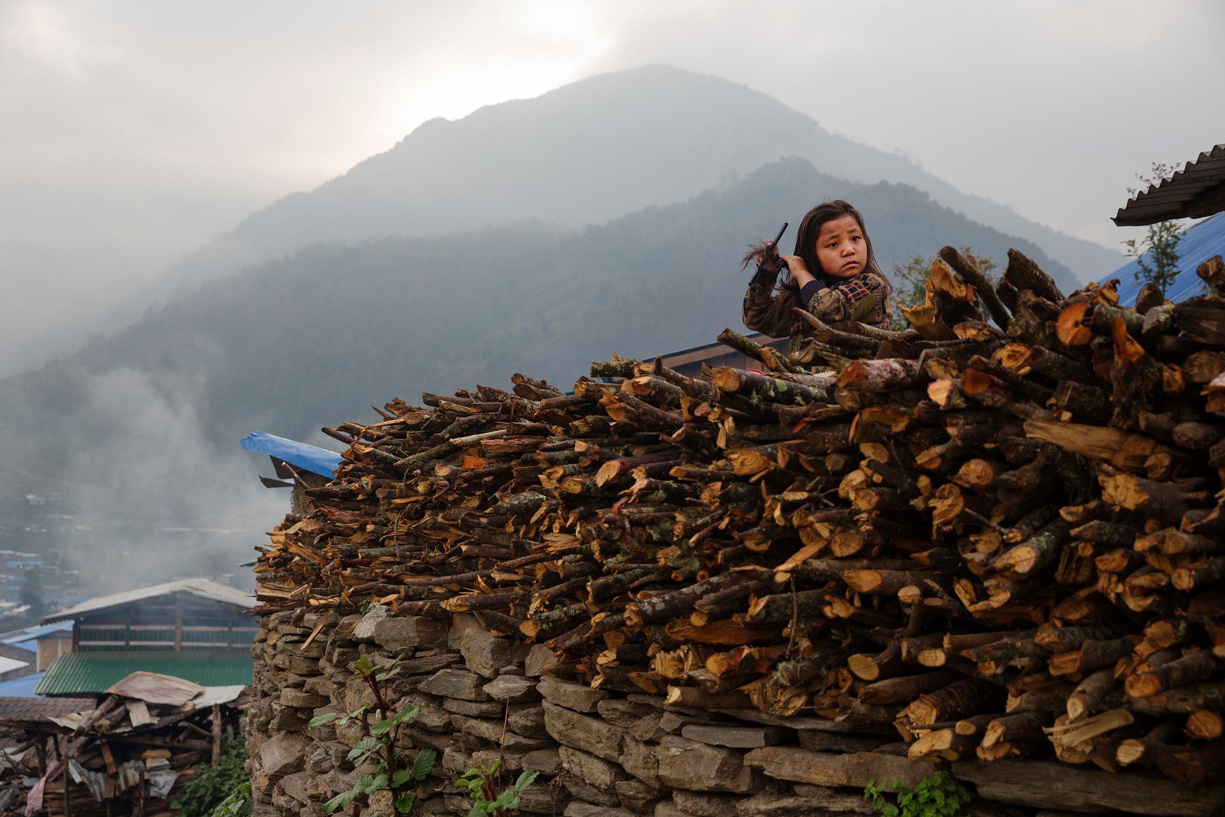 A child combs her hair in the devastated village of Barpak, in Gorkha district, Nepal, a year after the 2015 quakes which destroyed most of the town, April 5, 2016.