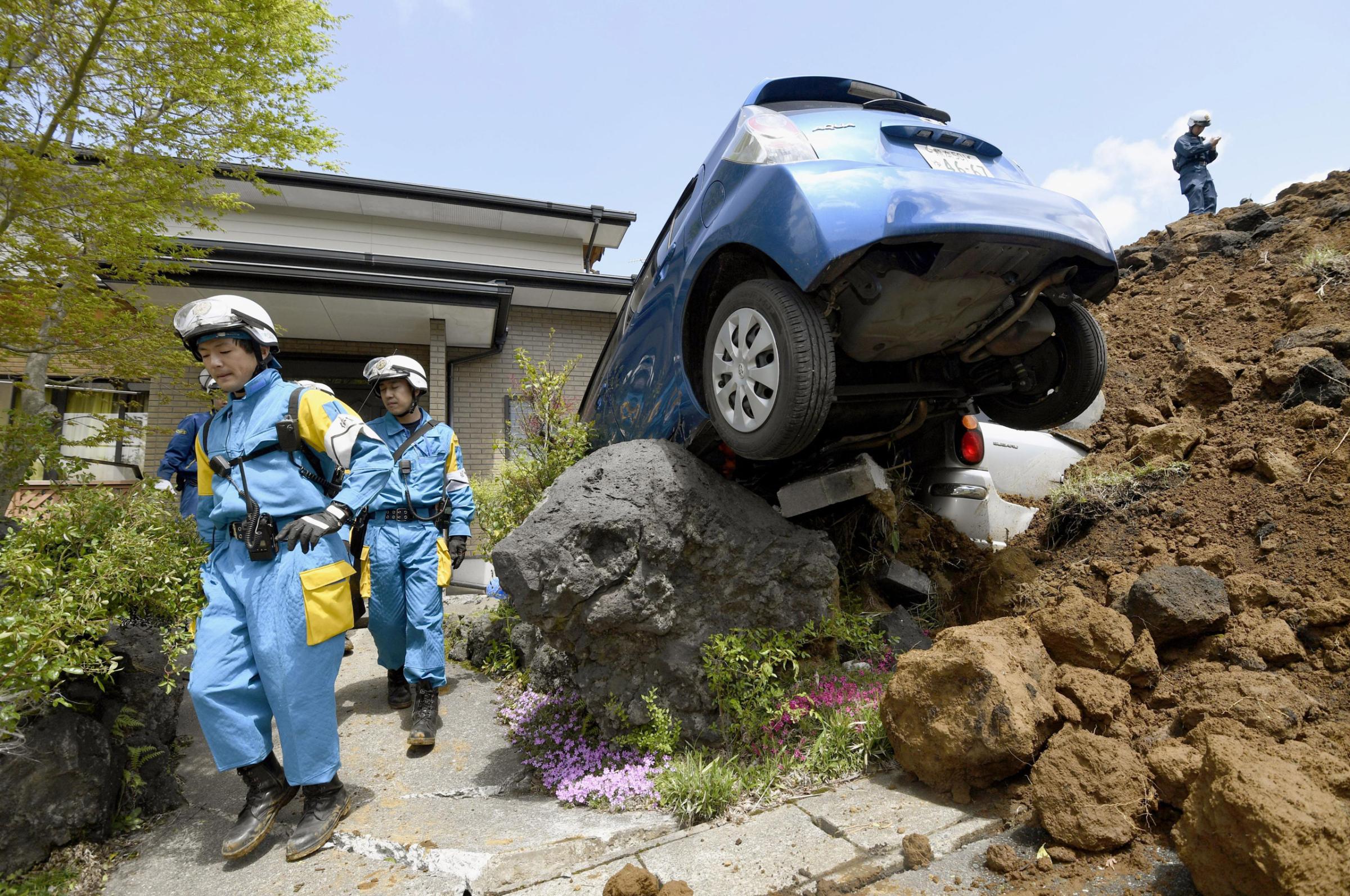 Police officers conduct a search operation at the site of a landslide caused by an earthquake in Minamiaso, Kumamoto prefecture, Japan, Sunday, April 17, 2016. Two nights of increasingly terrifying earthquakes flattened houses and triggered major landslides in southern Japan. (Yohei Fukai/Kyodo News via AP) JAPAN OUT, MANDATORY CREDIT