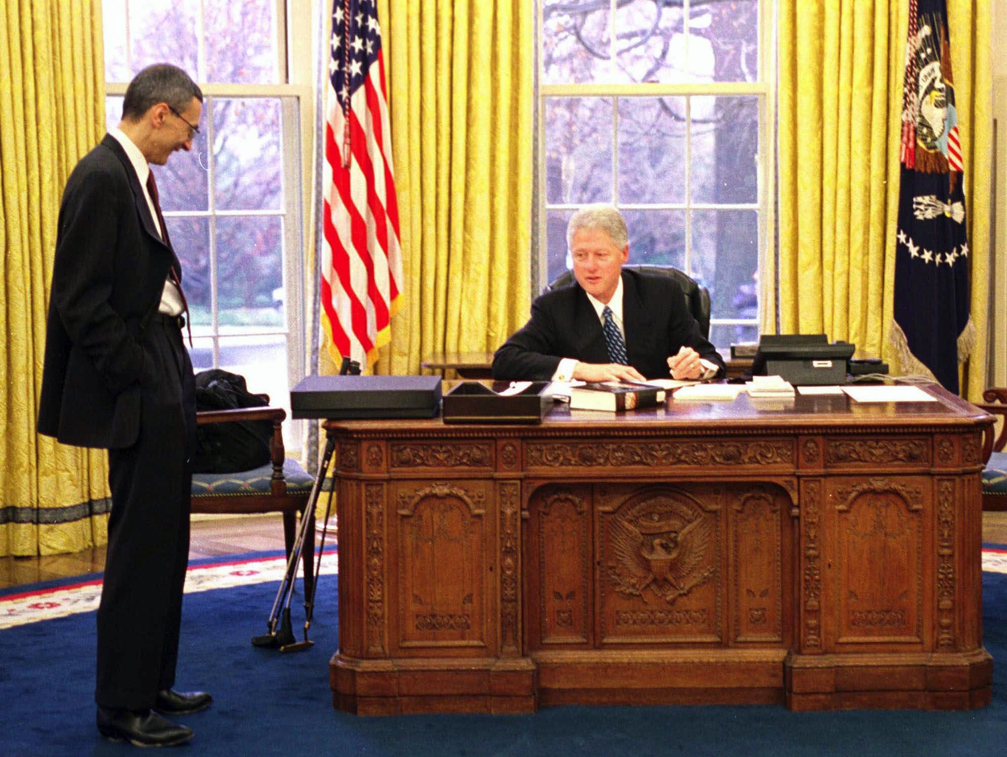 President Bill Clinton talks with White House Chief of Staff John Podesta on Jan. 20, 2001, in his last moments in the Oval Office before the president-elect's inauguration in in Washington.