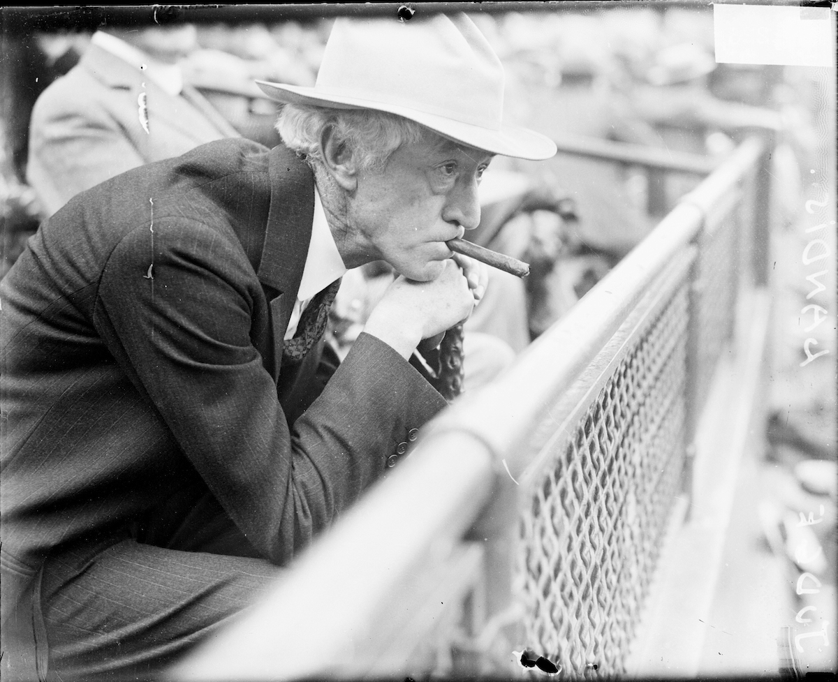 Judge Kenesaw Mountain Landis, commissioner of baseball from 1920-1944, sitting in profile in the stands at a baseball game in an outdoor stadium in Chicago, 1929. (Chicago History Museum / Getty Images)