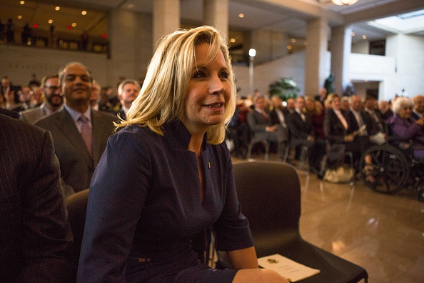 Liz Cheney, daughter of former Vice President Dick Cheney, watches as her father and mother unveil a marble bust made in his likeness during a ceremony in Emancipation Hall at the U.S. Capitol December 3, 2015 in Washington, DC. (Keith Lane—Getty Images)