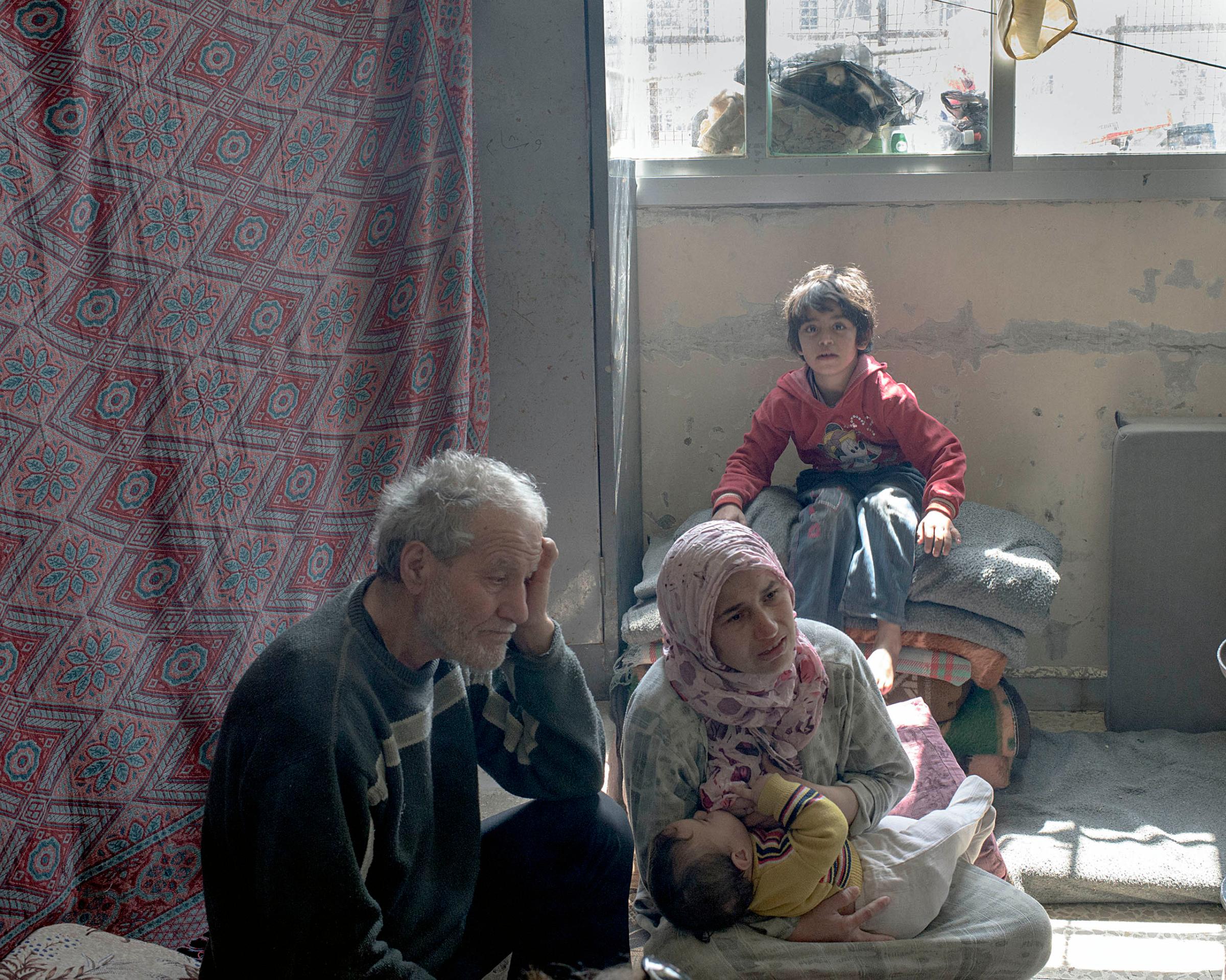 Internally displaced persons live in a former school, converted into a refugee center by the Syrian Arab Red Crescent, in the Bab Amr district of Homs, Syria, March 2016.