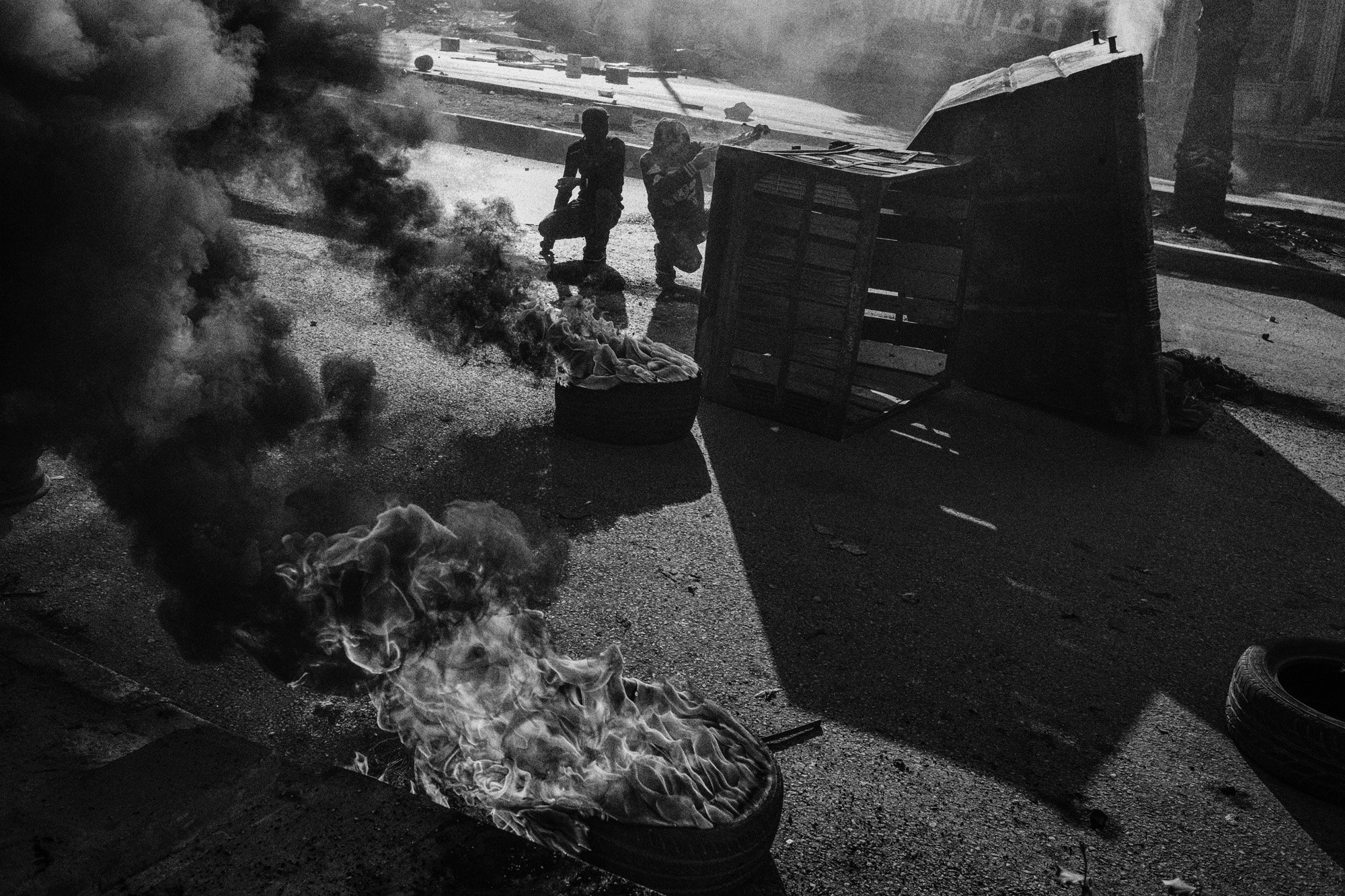 Youth burn tires during a demonstration in central Hebron, November 2015.