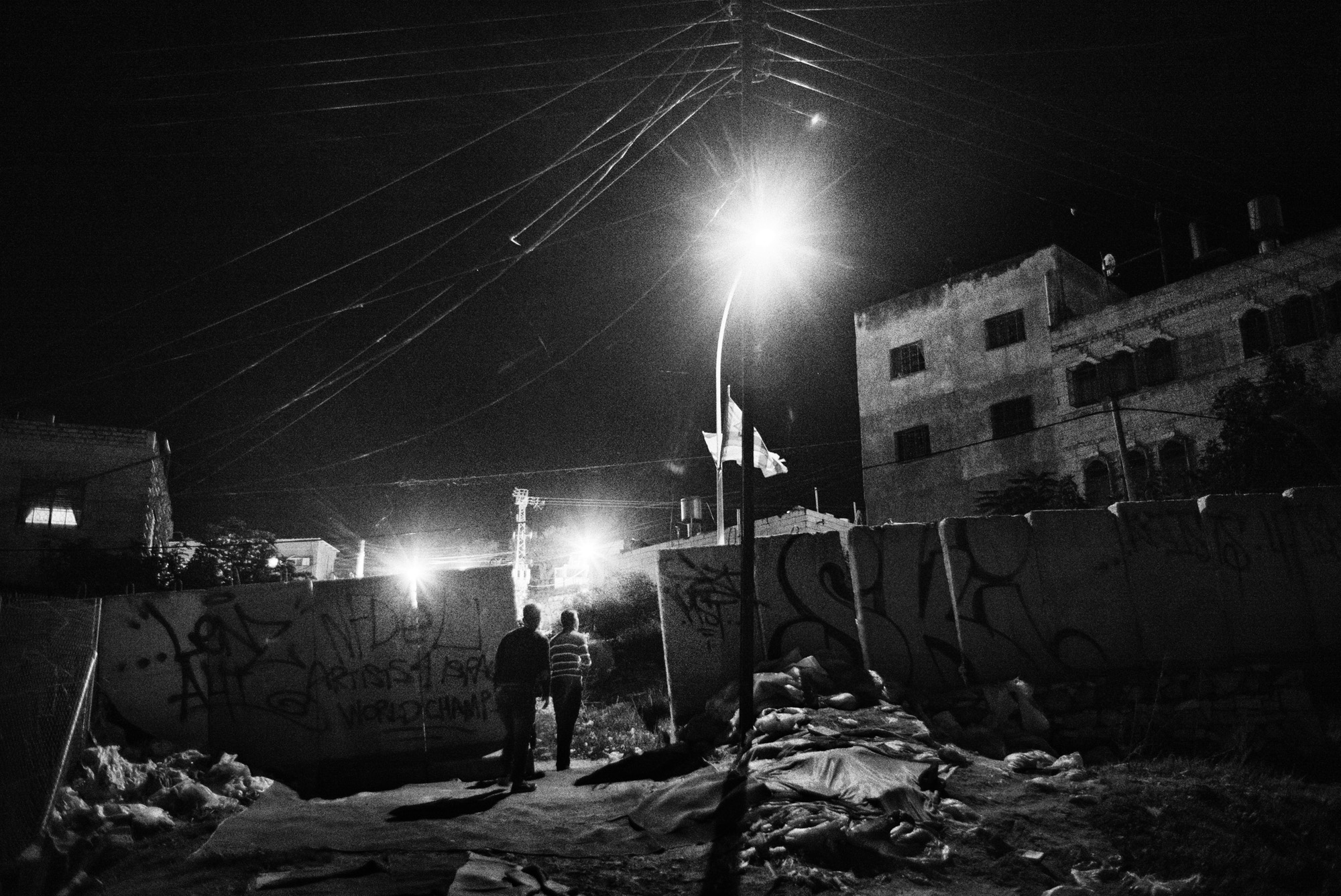 Residents of Tel Rumeida walk home at night, Hebron, November 2015.