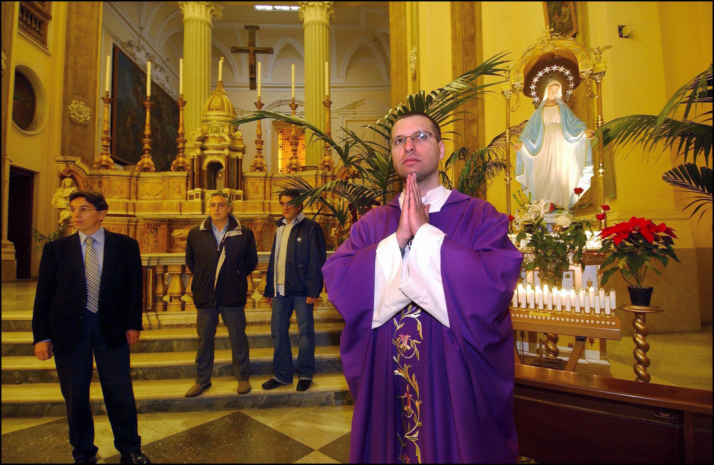Don Luigi Merola and his three bodyguards before Mass at San Giorgio Maggiore in the heart of Naples, Italy, Dec. 13, 2004.