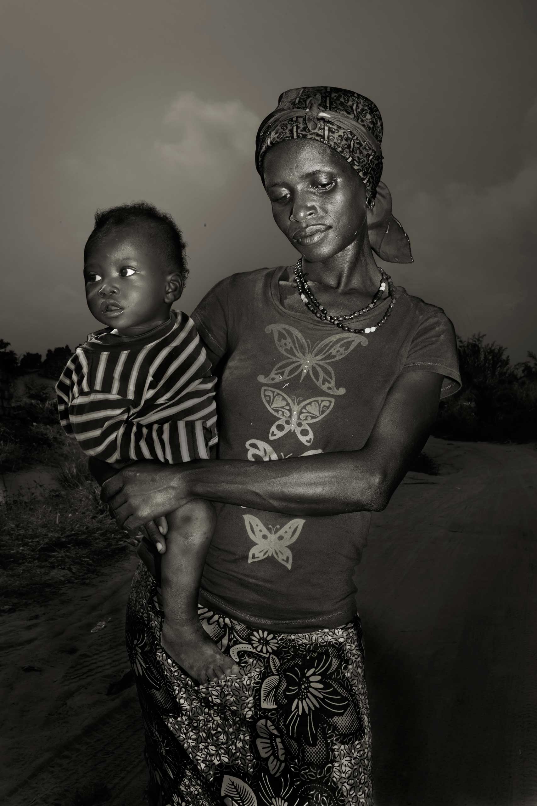 Professional Portraiture First Place. Ebola Survivors. Fatmata Kamara, 25, with her son Koday, 1. She contracted ebola together with her son. They both survived the infection and live in Waterloo, a village developed from a refugee camp,