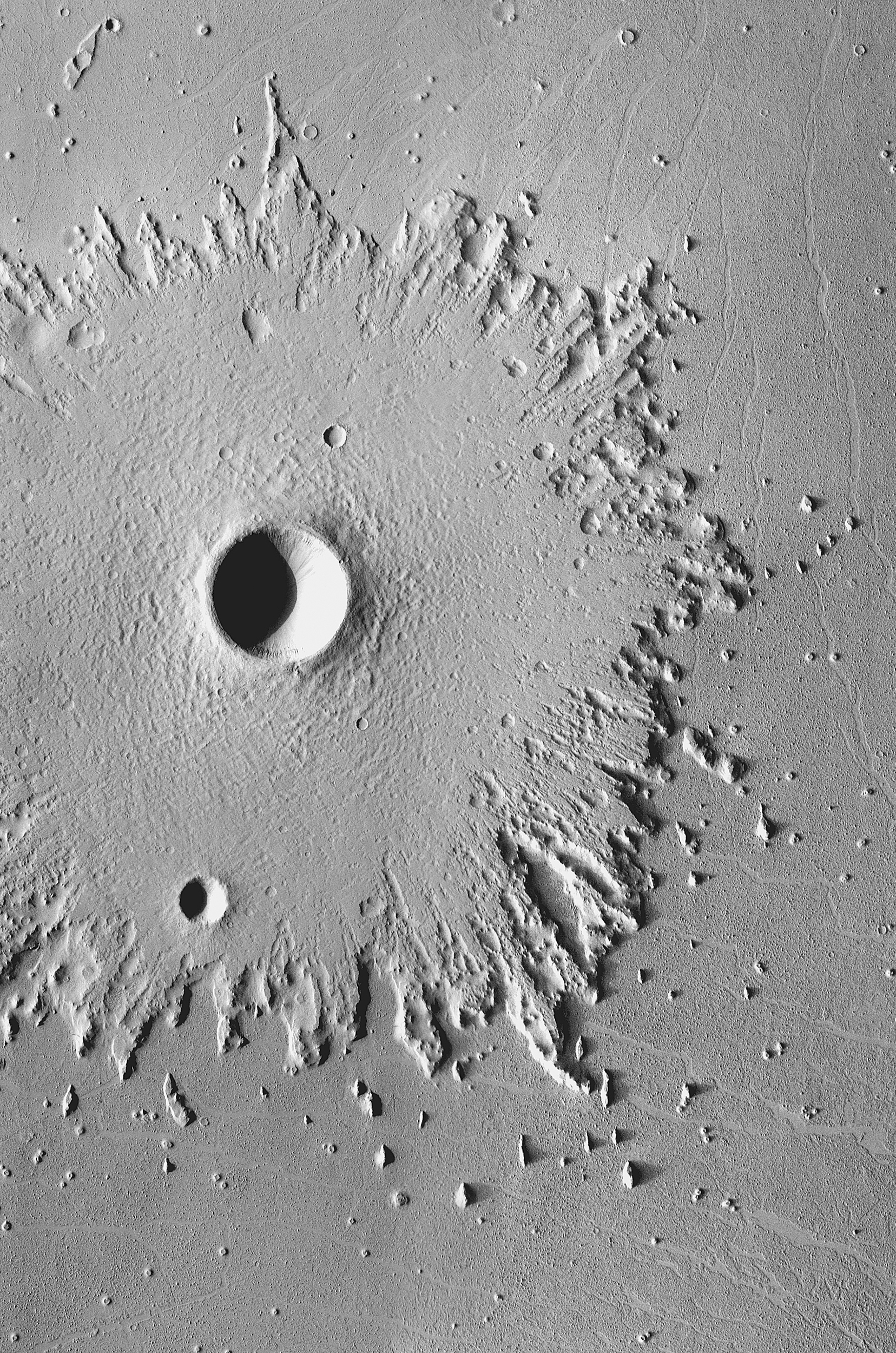 Radical Erosion: The wide, circular blanket of ejected debris surrounding this crater has become greatly eroded by the wind, which has stripped its surface features. This images was acquired between May 2003 and April 2006 by the Thermal Emission Imaging System instrument on NASA's Mars Odyssey orbiter.