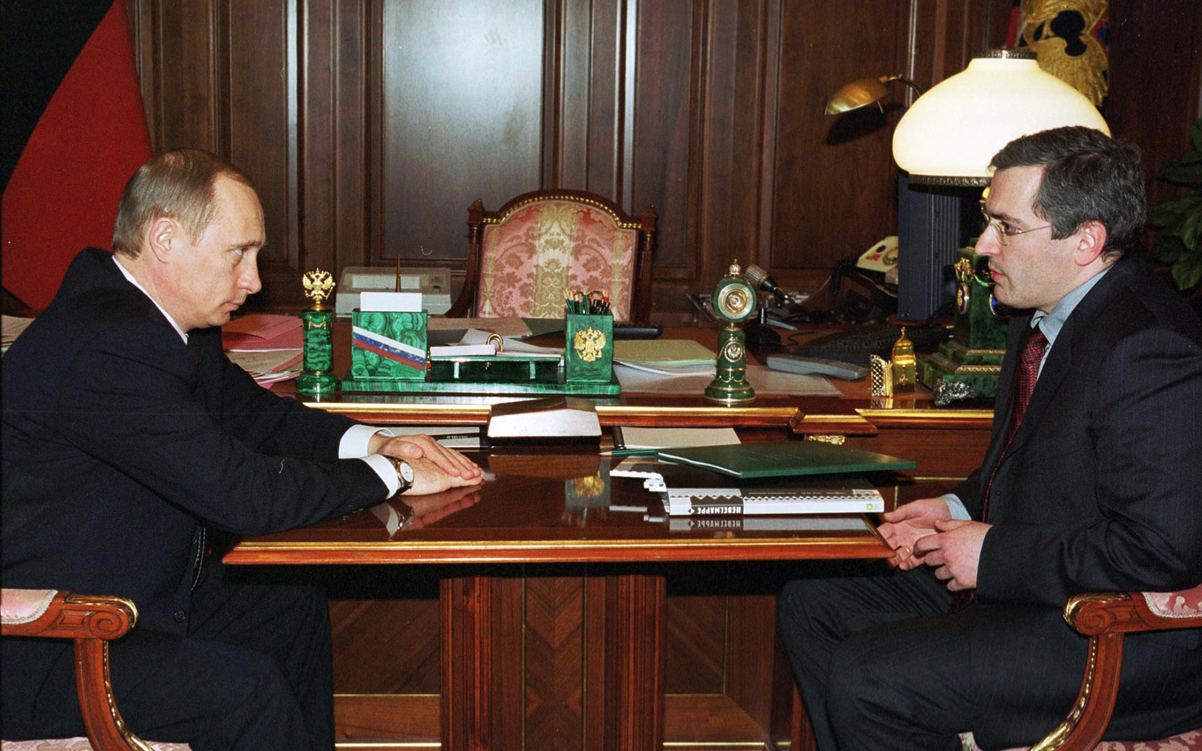 President Vladimir Putin, right, during the meeting with Mikhail Khodorkovsky, board chairman of the Yukos oil company, in the Kremlin in Moscow, Russia, March 14, 2002.