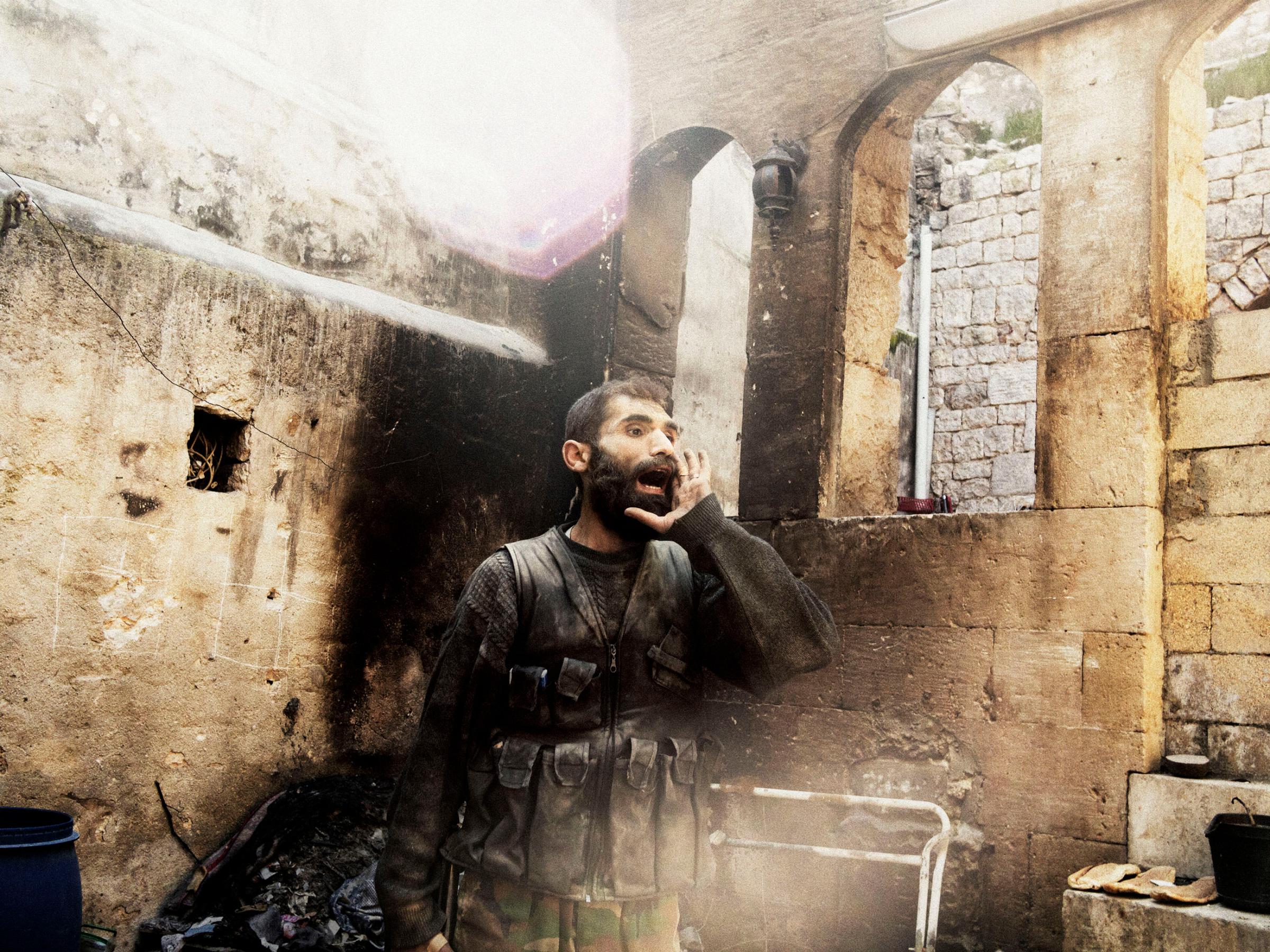 SYRIA. Aleppo. 2013.  A rebel yells “Allahu Akbar” (God is Great) during close-quarters fighting in Aleppo’s Old City.