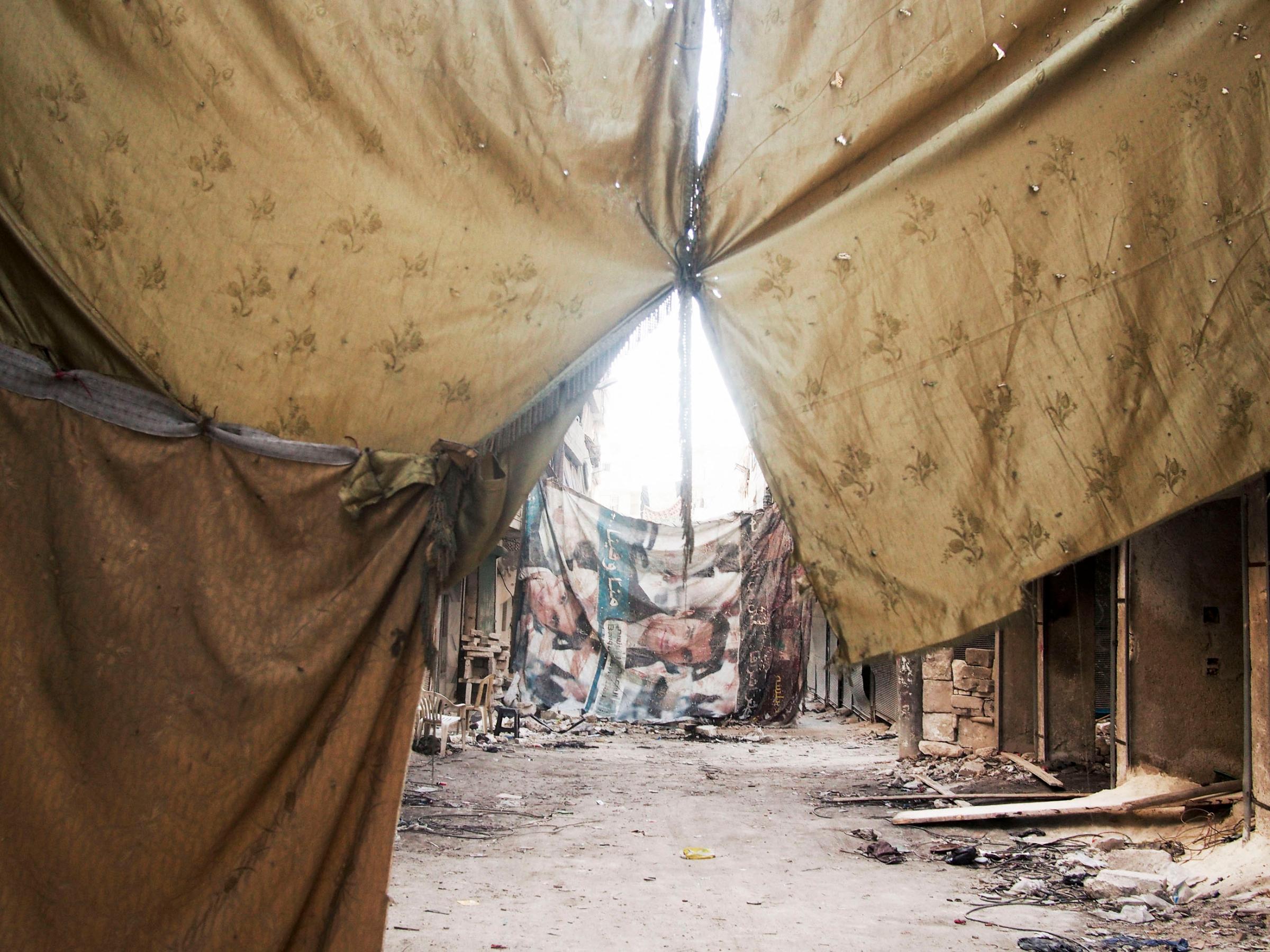 SYRIA. Aleppo. March 23, 2013. Makeshift sheets and blankets sewn together obstruct the view from regime snipers in the Al-Amiriya front line of city.