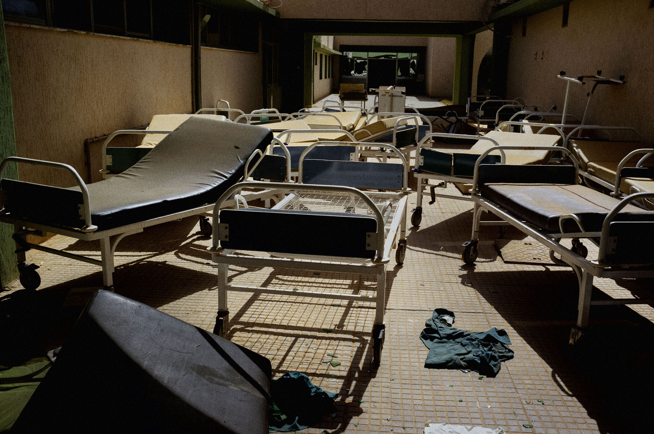 Hospital beds in a courtyard inside the abandoned hospital in Tawerga. Qaddafi troops had used Tawerga as a staging ground for their brutal assault on Misurata last spring. As a result, several weeks ago, all of Tawerga's residents fled the town, fearing retribution by advancing rebels from Misurata. Libya, 2011.