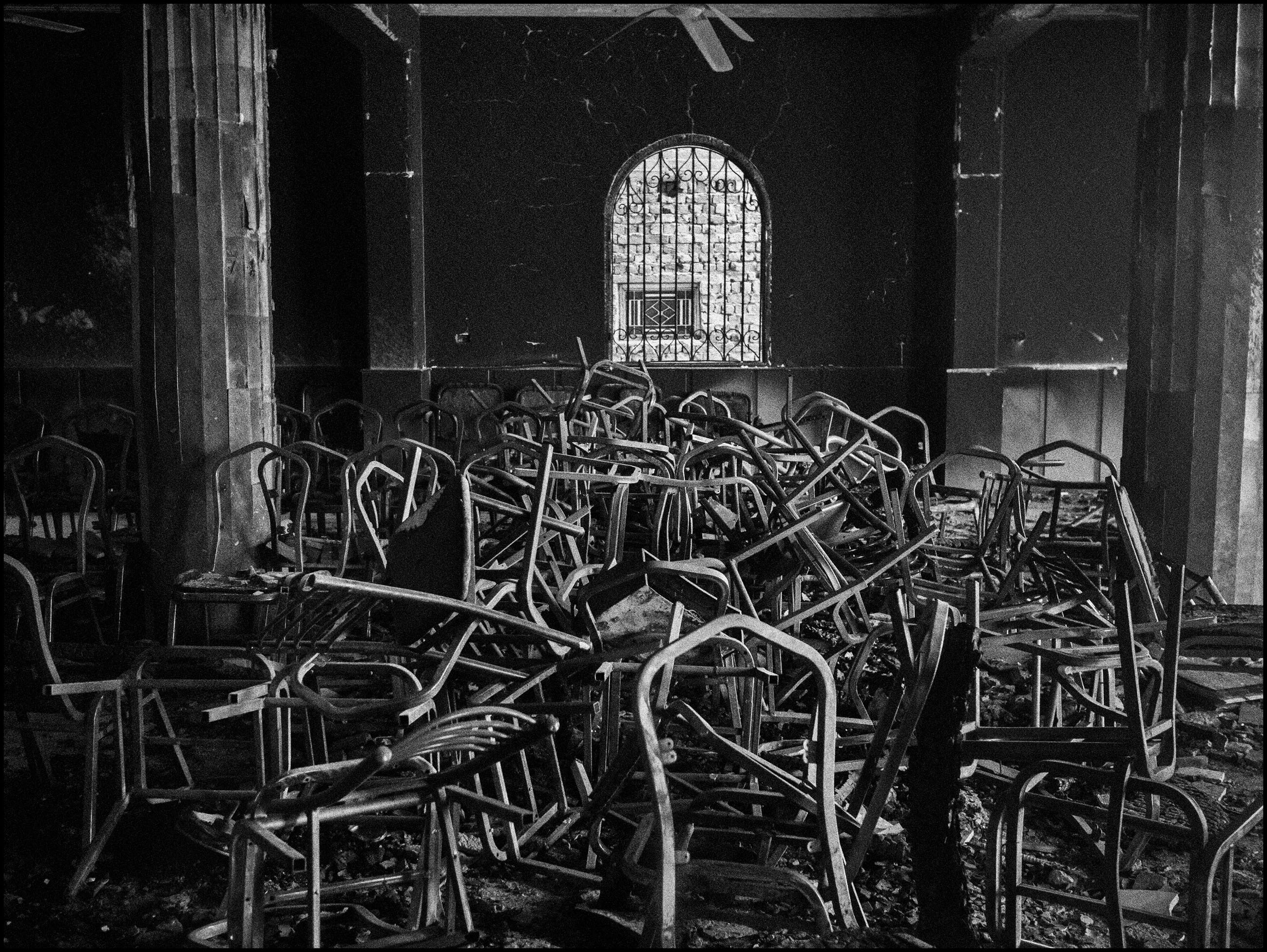 Burned chairs inside a church damaged during an Islamist mob attack. Al Nazla, Egypt, 2013.