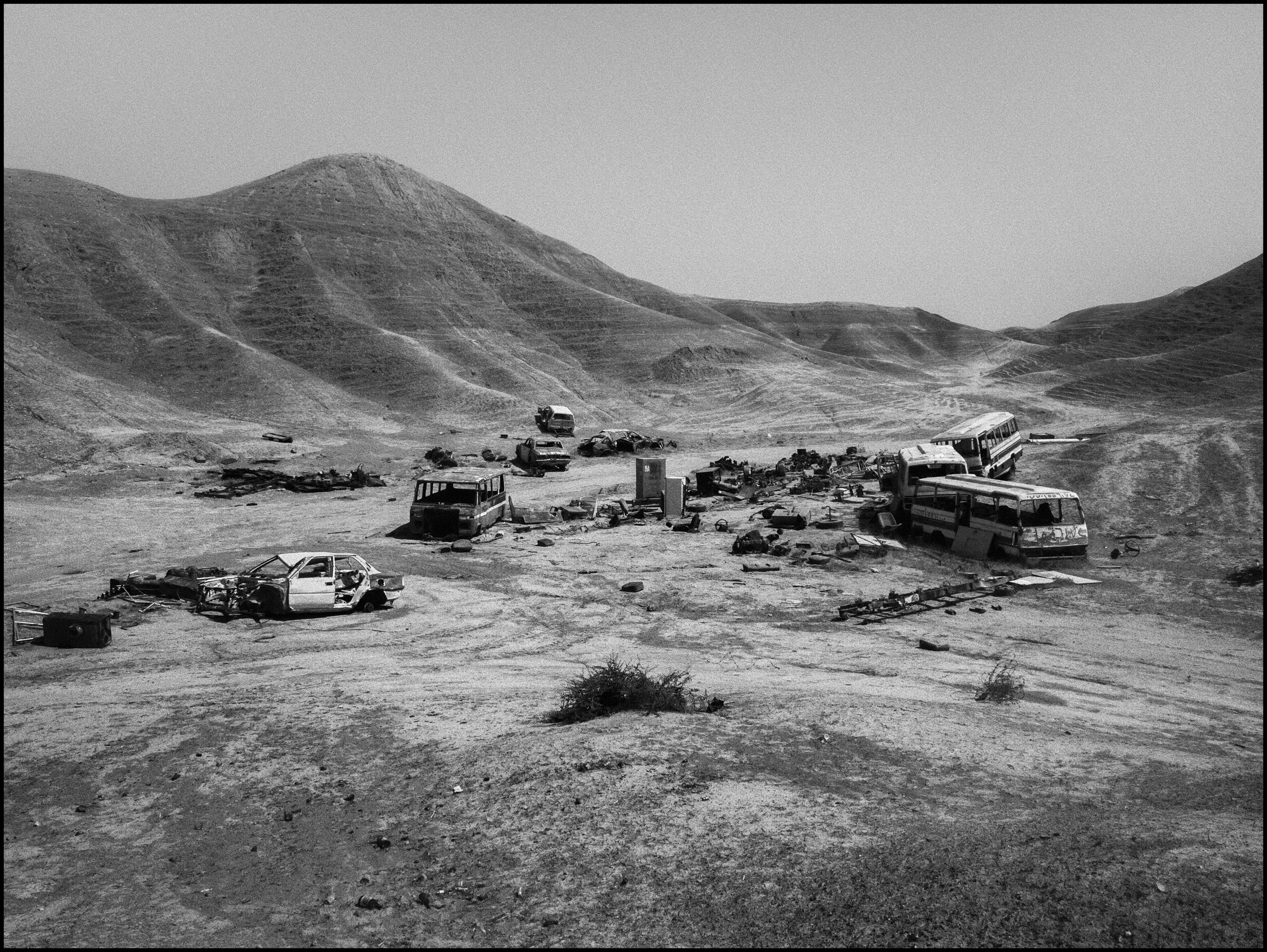 Destroyed vehicles litter a hill at the eastern entrance to Kirkuk, Iraq, 2014.