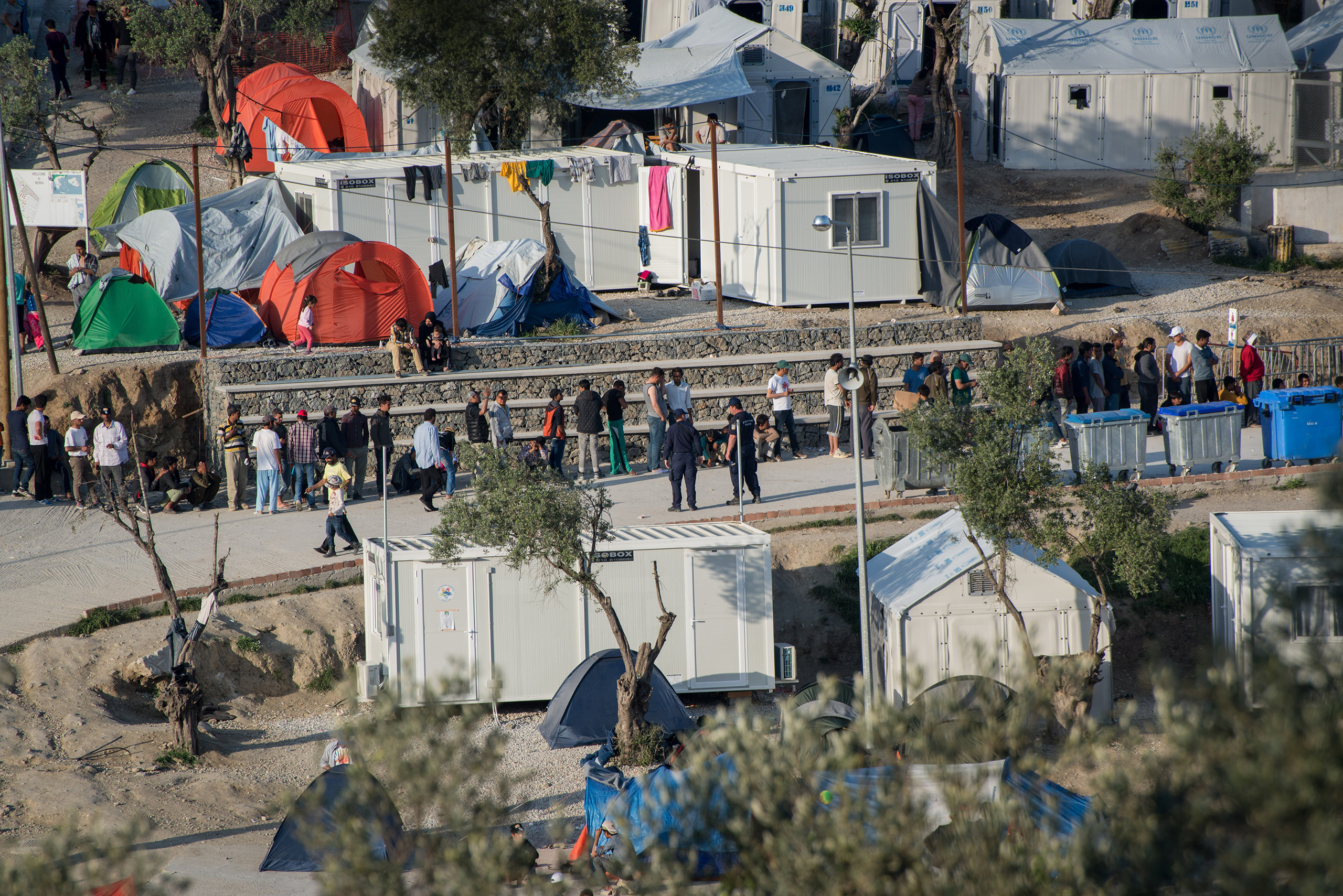 People wait in line at the Moria camp for migrants and refugees located in Mytilene, on the Greek island of Lesbos, April 13, 2016. Pope Francis will visit the island on April 15. (Guillaume Pinon—NurPhoto/Sipa USA)