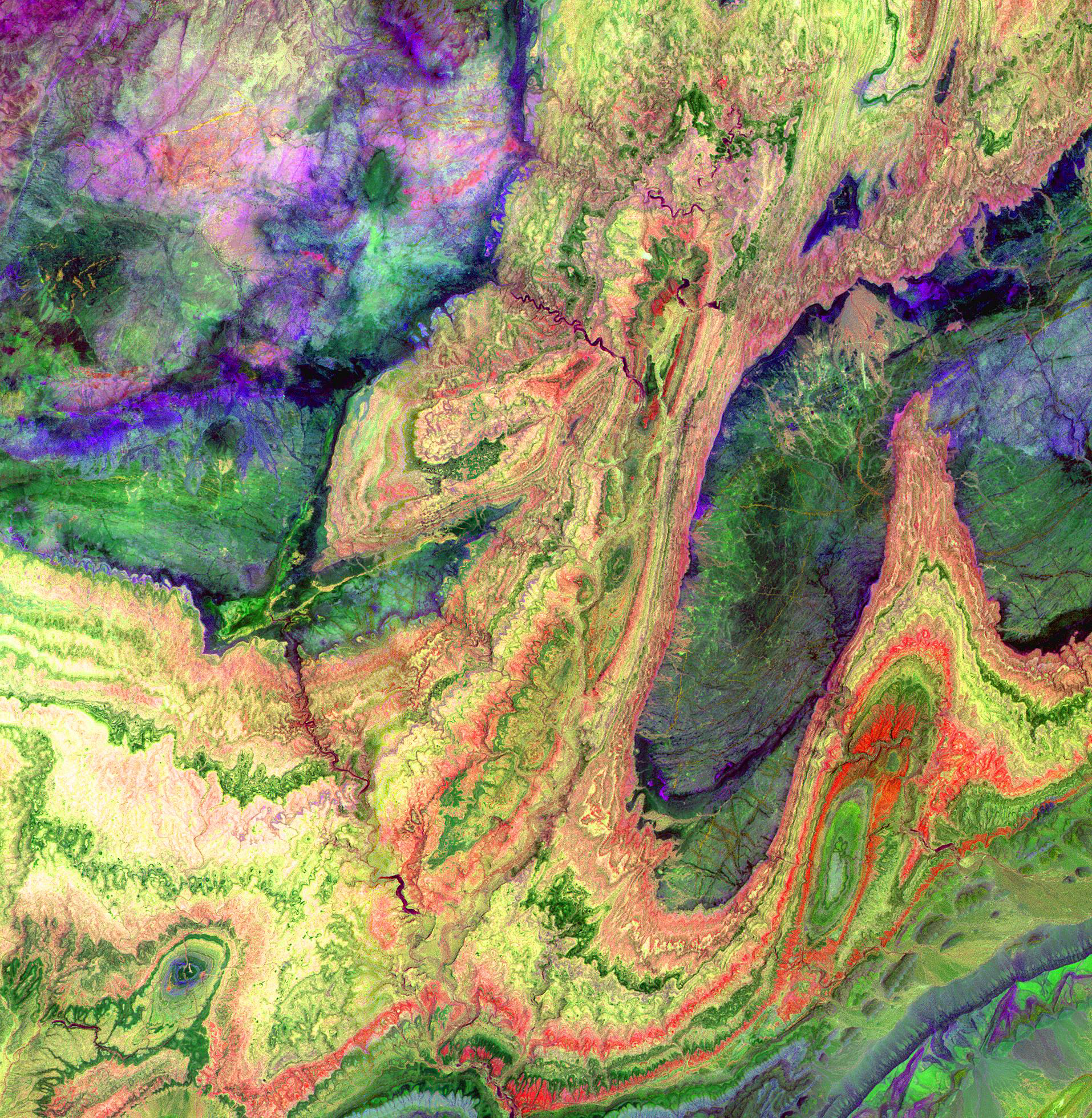 The Anti-Atlas Mountains, Morocco, formed as a result of the collision of the African and Eurasian tectonic plates about 80 million years ago. In this image, short wavelength infrared bands are combined to dramatically highlight the different rock types, and illustrate the complex folding. The yellowish, orange and green areas are limestones, sandstones and gypsum; the dark blue and green areas are underlying granitic rocks. The image was acquired on June 13, 2001.