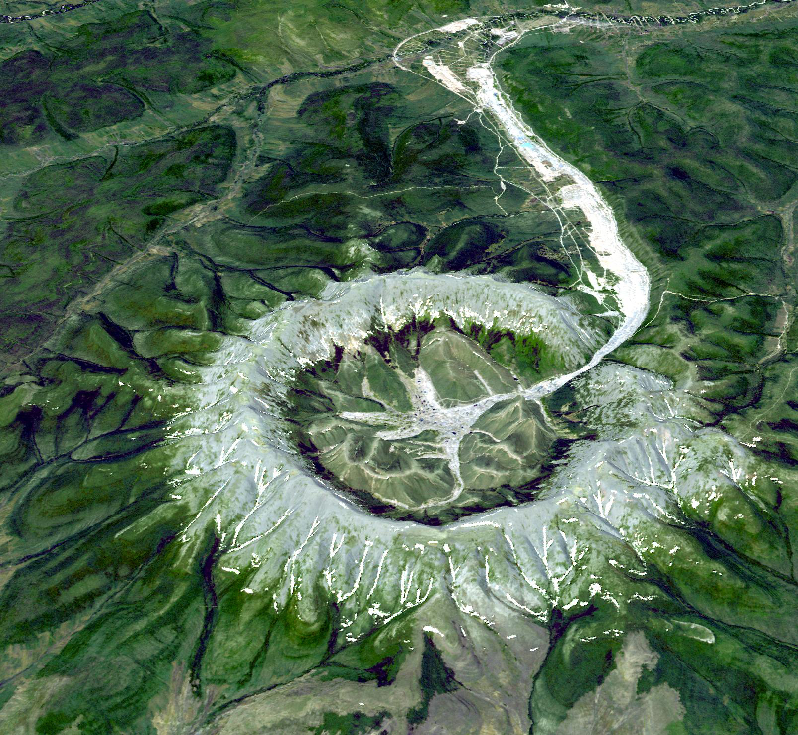 The Kondyor Massif in Eastern Siberia, Russia, is a rare form of igneous intrusion called alkaline-ultrabasic massif and it is full of rare minerals. The river flowing out of it forms placer mineral deposits. The image was acquired on June 10, 2006.