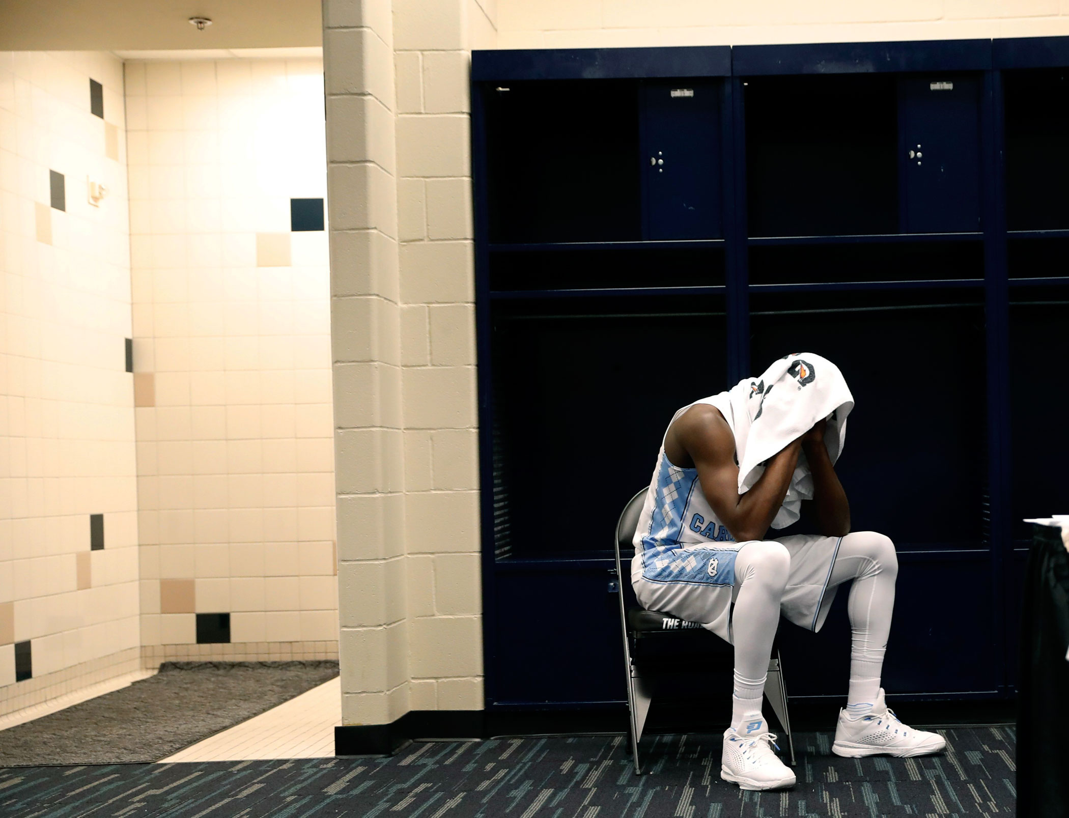 North Carolina's Theo Pinson sits in the locker room after Villanova defeated North Caroline in the NCAA college basketball National Championship game on April 4, 2016 in Houston.