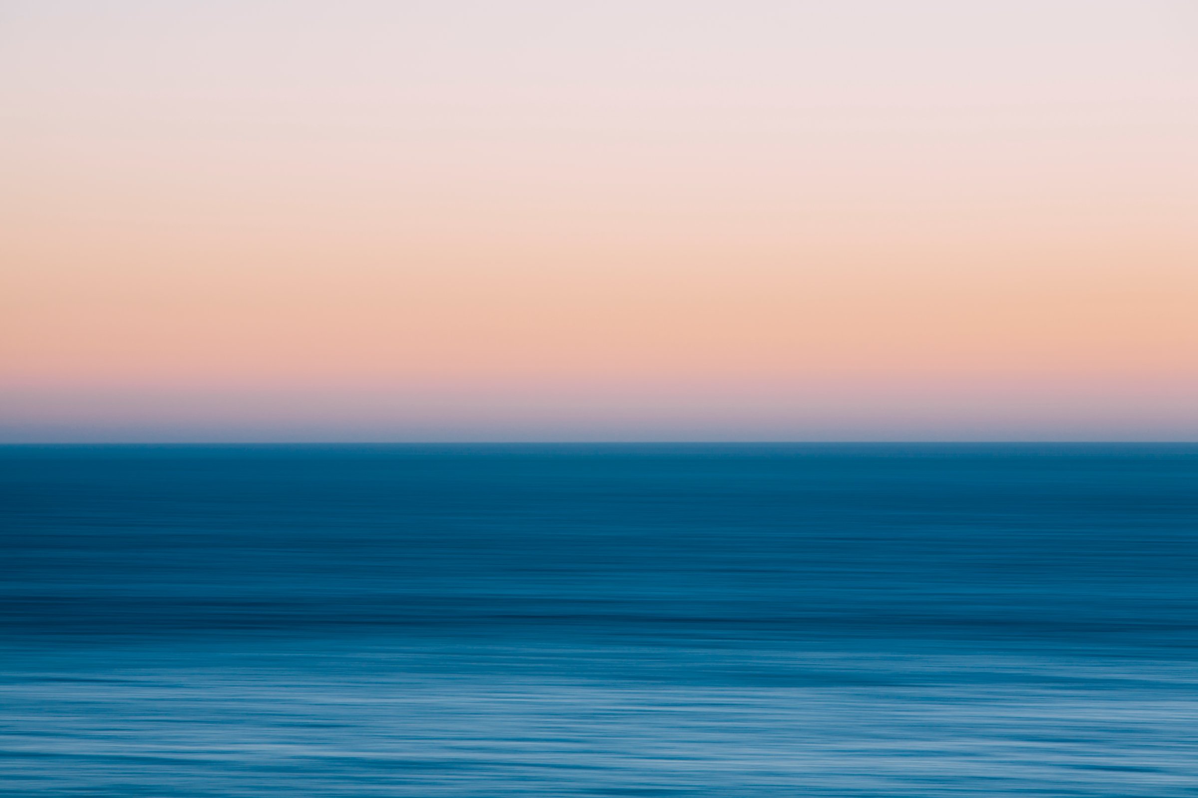 A view out to sea over the Pacific Ocean at dusk. Blurred motion.