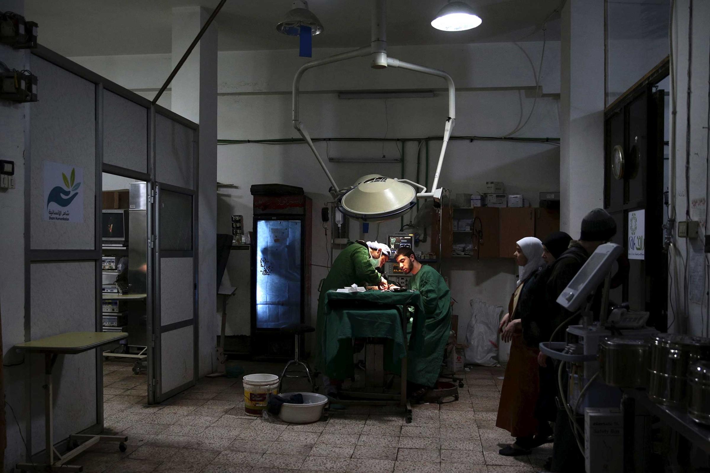 Doctors treat an injured civilian in a field hospital after what activists said was shelling by forces of Syria's President Bashar al-Assad in the Douma neighbourhood of Damascus, Eastern Ghouta, Syria November 19, 2015.