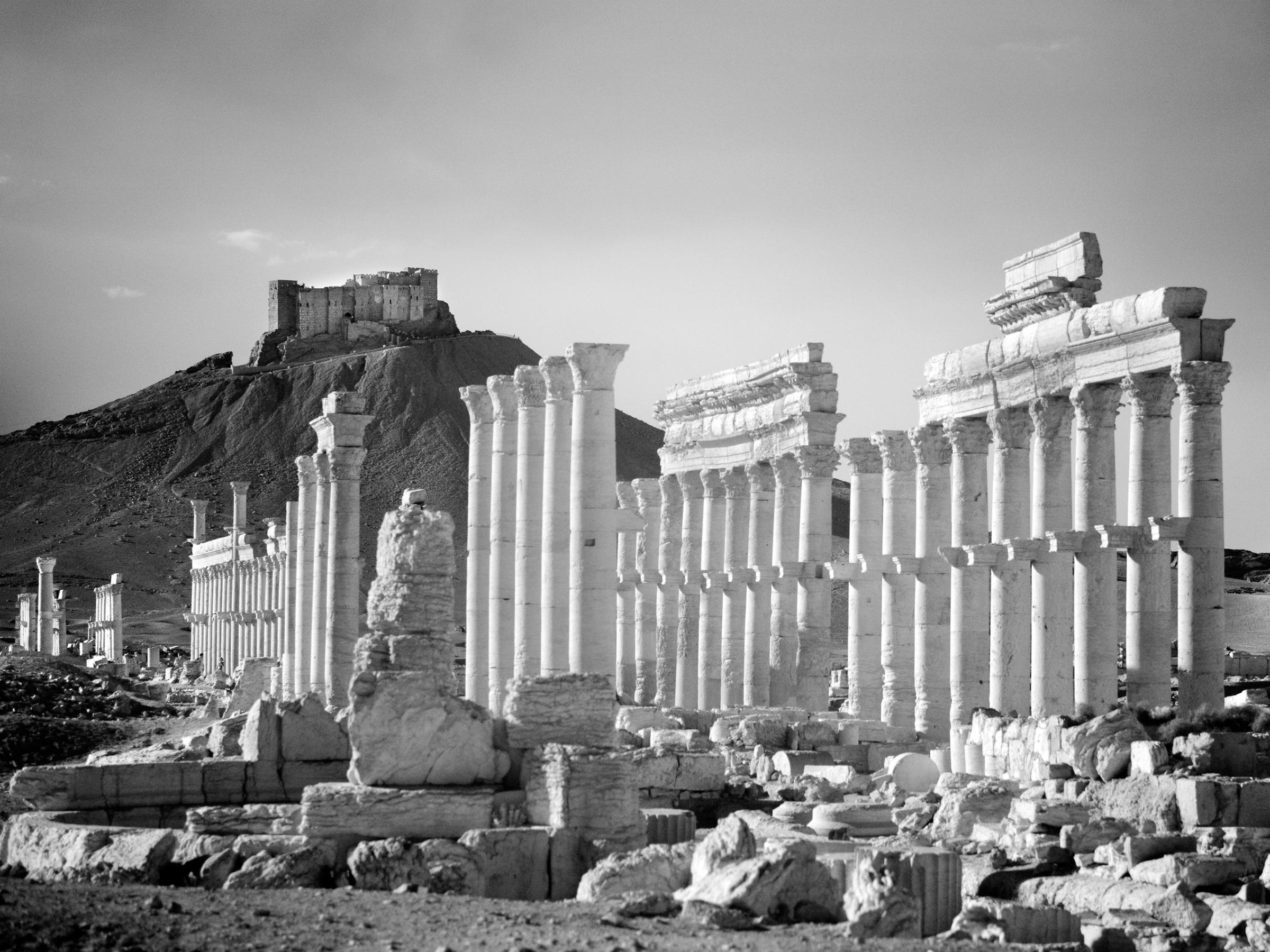 Qalaat Shirkuh looms above the ancient Roman city of Palmyra.