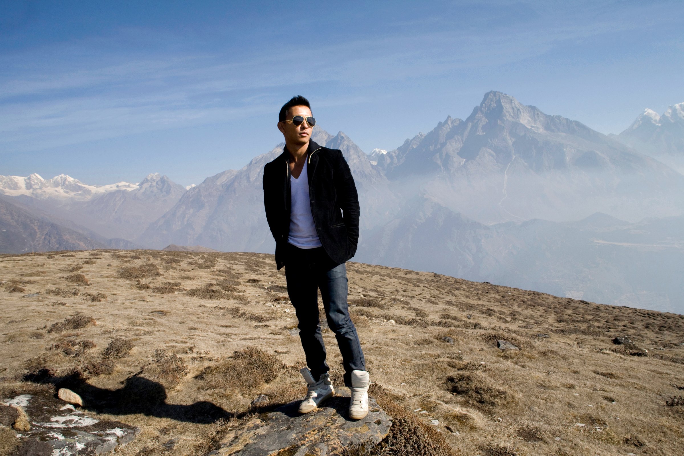 Nepali fashion designer Prabal Gurun poses at the foot of Kondge mountain at more than 13,000 feet above sea level, with the Khumbu valley behind him on April 7, 2010.