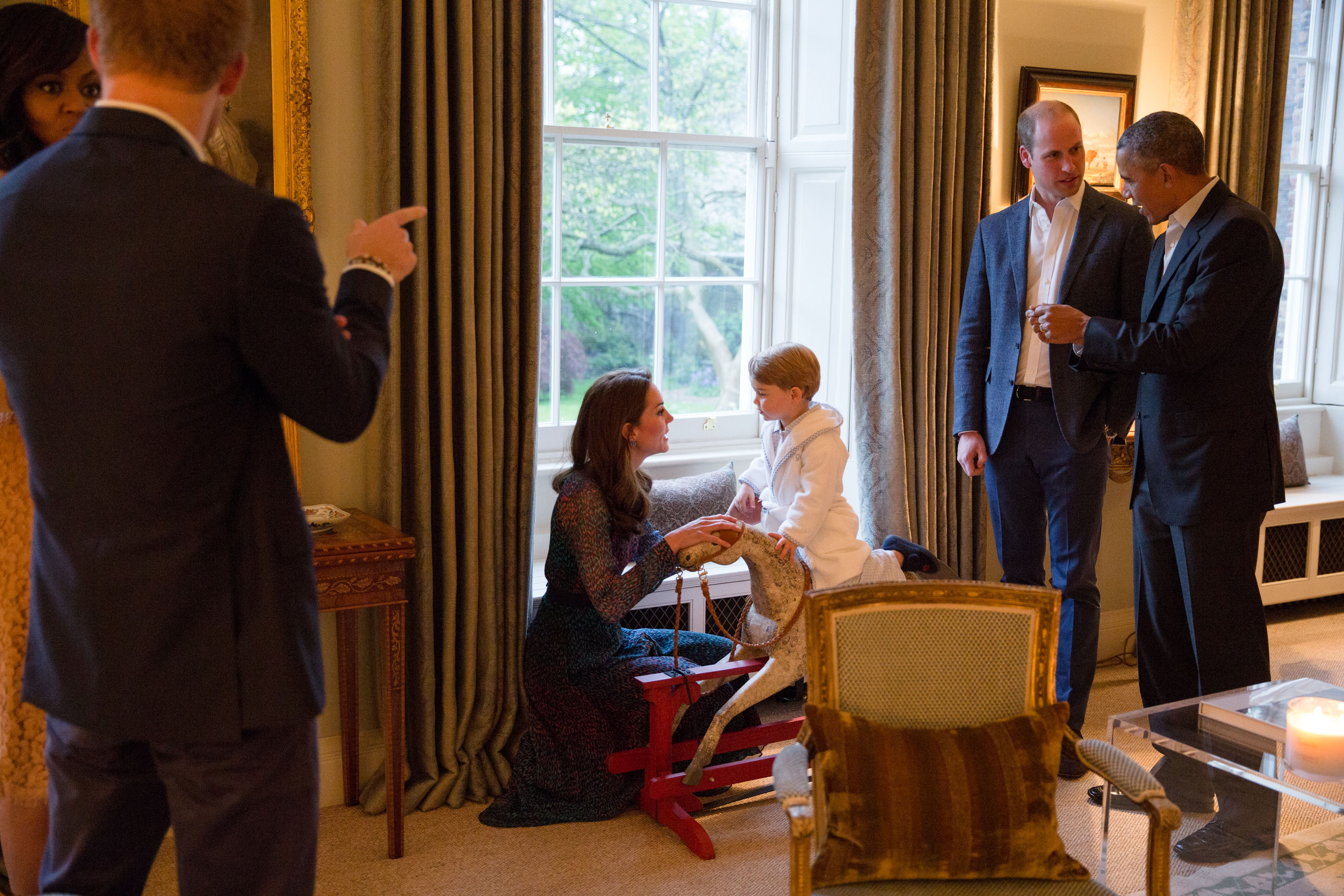 Prince George displays the robe from a rocking horse with the ease of a seasoned runway model as he meets the President and First Lady on April 22, 2016.