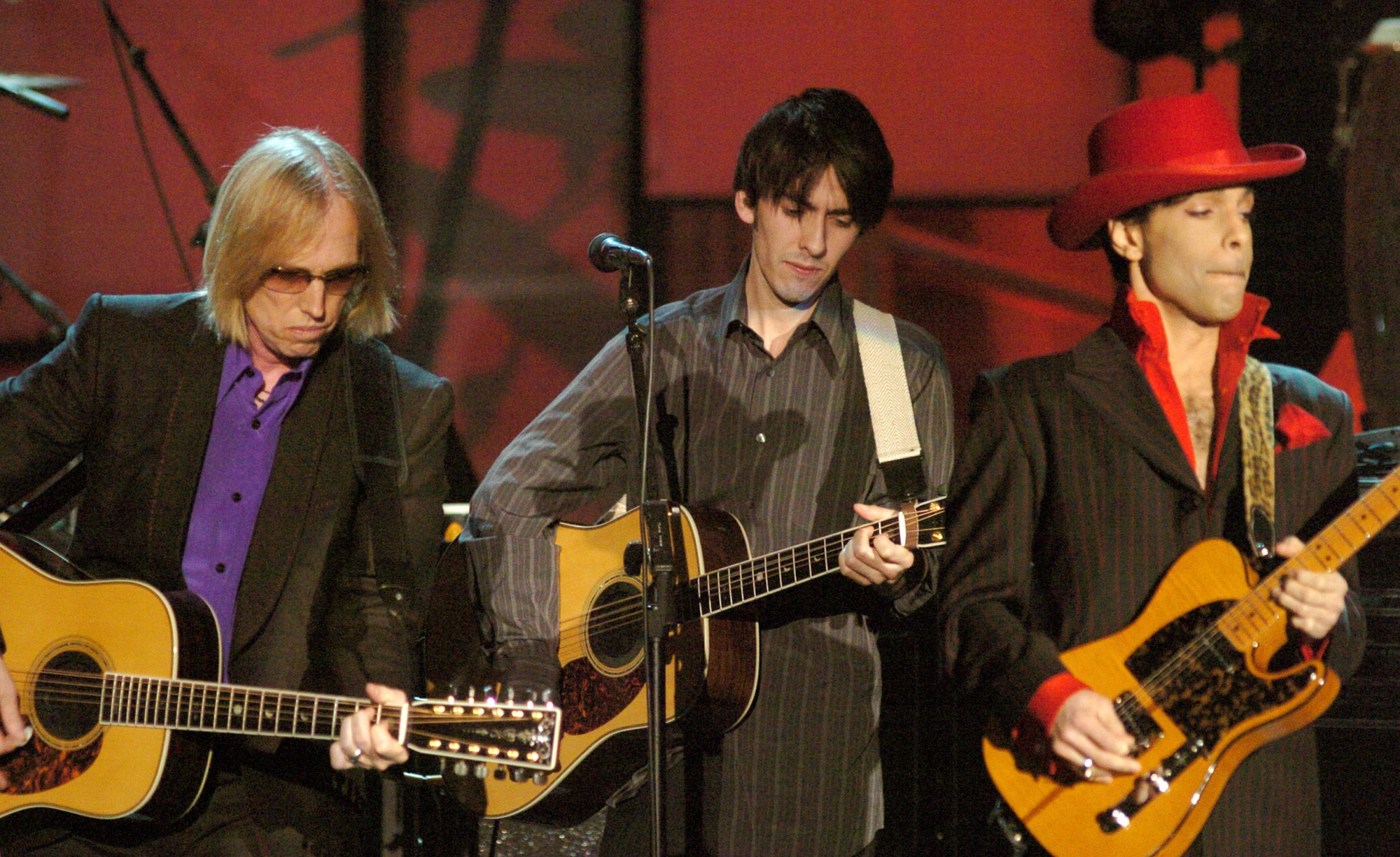 From left: Tom Petty, Dhani Harrison and Prince perform during The 19th Annual Rock and Roll Hall of Fame Induction Ceremony in New York City on March 15, 2004. Prince was inducted into the Hall of Fame that evening.