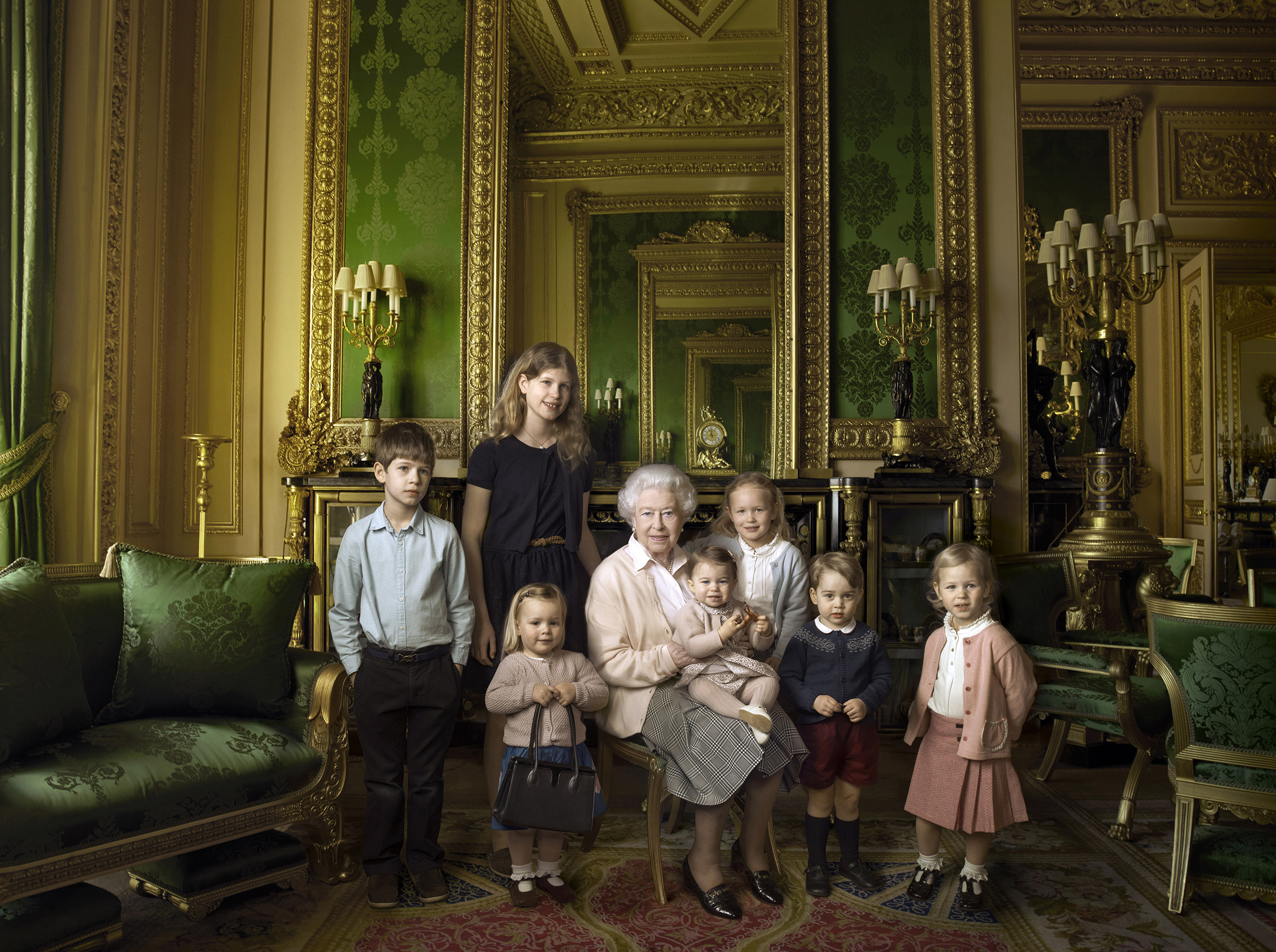 This official photograph released by Buckingham Palace to mark Queen Elizabeth II's 90th birthday shows her five great-grandchildren and her two youngest grandchildren in the Green Drawing Room, part of Windsor Castle's semi-State apartments, April 20, 2016. (REX/Shutterstock)
