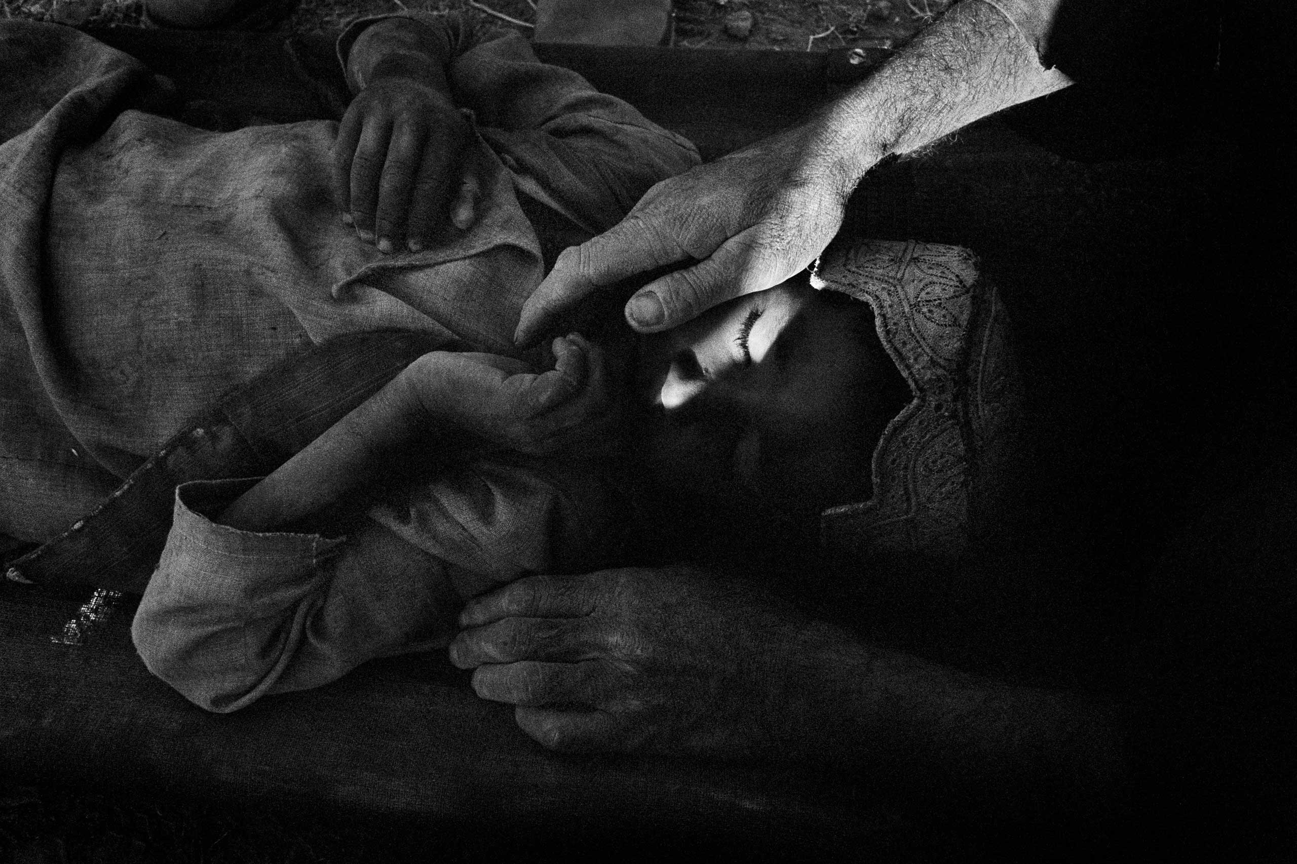 A wounded Afghan boy who had been shot in crossfire during a battle between US soldiers and Taliban in Gonbaz village, Kandahar Province, Oct. 1, 2005.