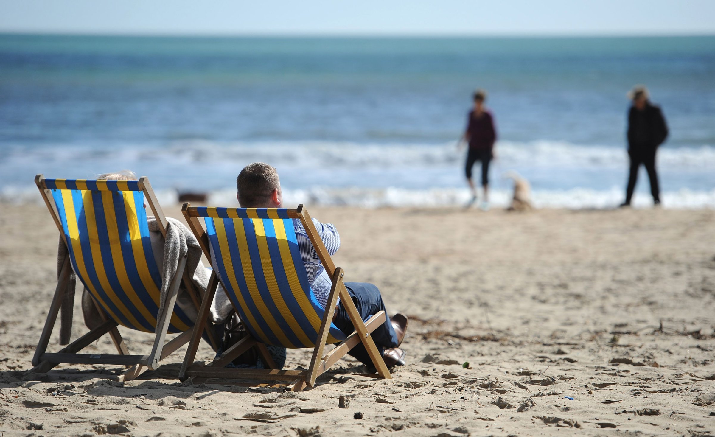Spring weather Mar 25th 2016. People enjoying the sun sitting in deckchairs on Bournemouth beach. Picture date: Friday March 25, 2016. See PA story WEATHER Easter. Photo credit should read: Andrew Matthews/PA Wire URN:25916481