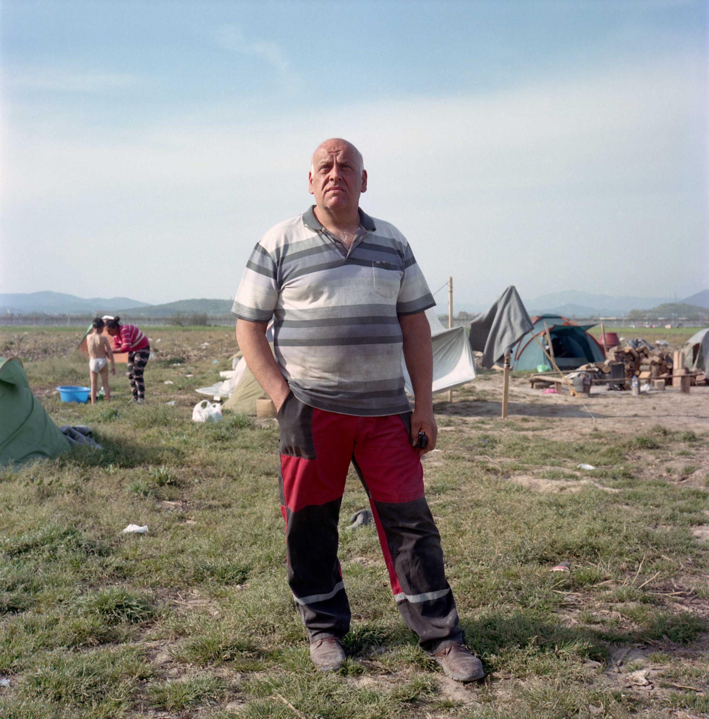 Lazarous Oulis, livestock farmer from Idomeni stands in a field where he planted crops to grow animal feed. Since September 2016, refugee tents have spread on nearly 250 acres of Lazaros Oulis'es land, all the way to the border with Macedonia, preventing him from working on his harvest and resulting in losses of Euro 20,000 for which he claims he had not received any compensation. Idomeni, Greece. April, 2016