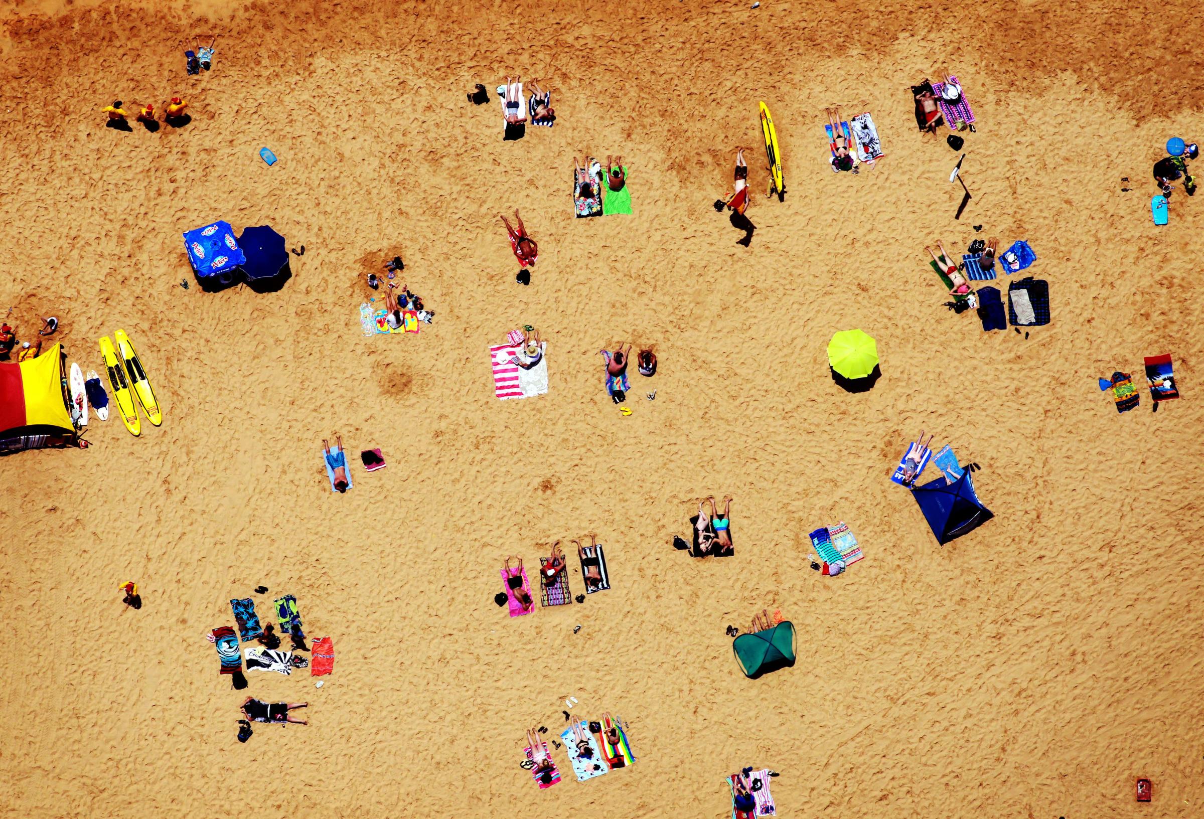 Beachgoers relax at Terrigal Beach as summer arrives on the Central Coast of New South Wales, Australia, Dec. 1, 2012.