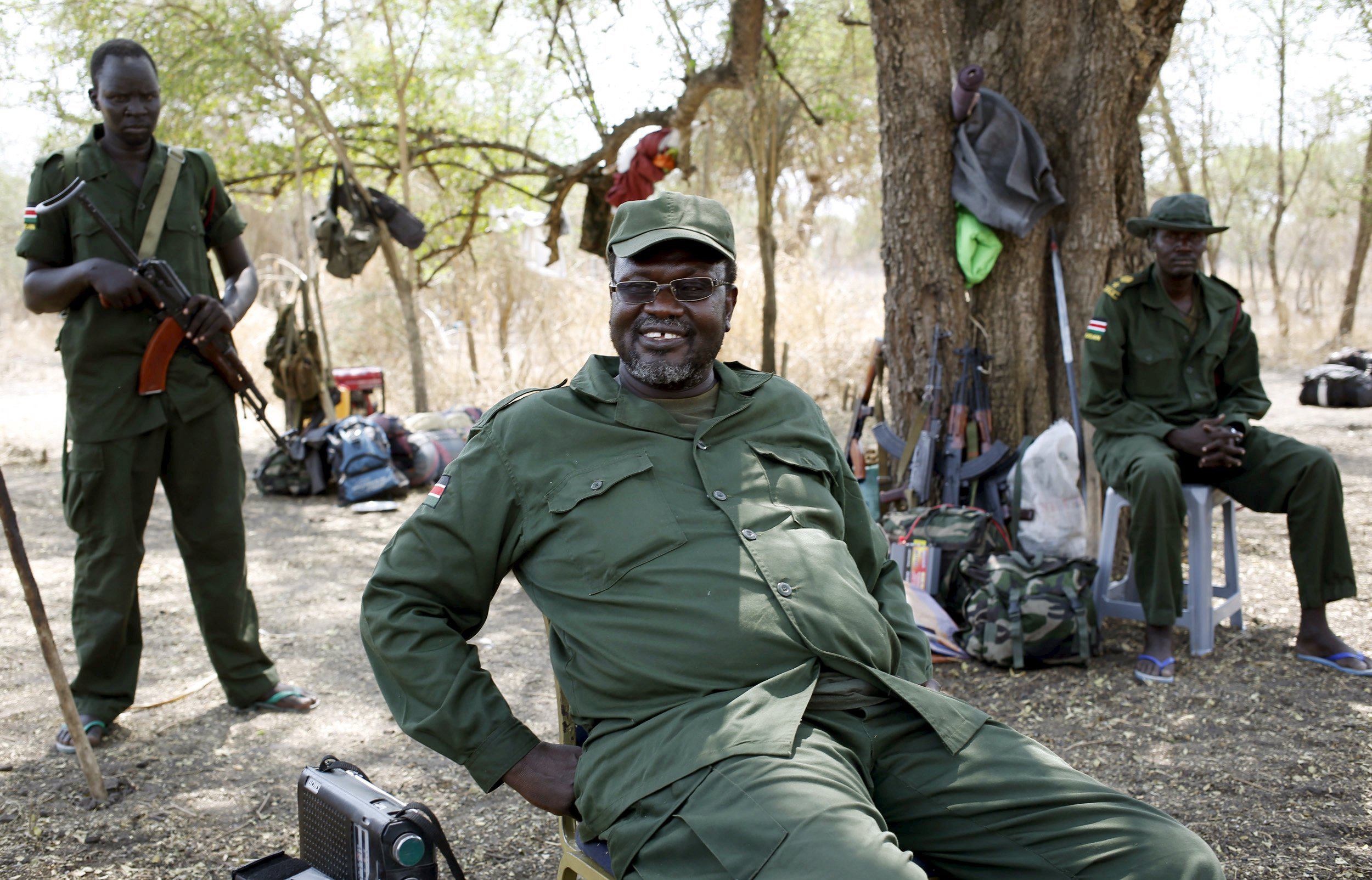 A file photo shows South Sudan's rebel leader Machar sitting near his men in a rebel-controlled territory in Jonglei State