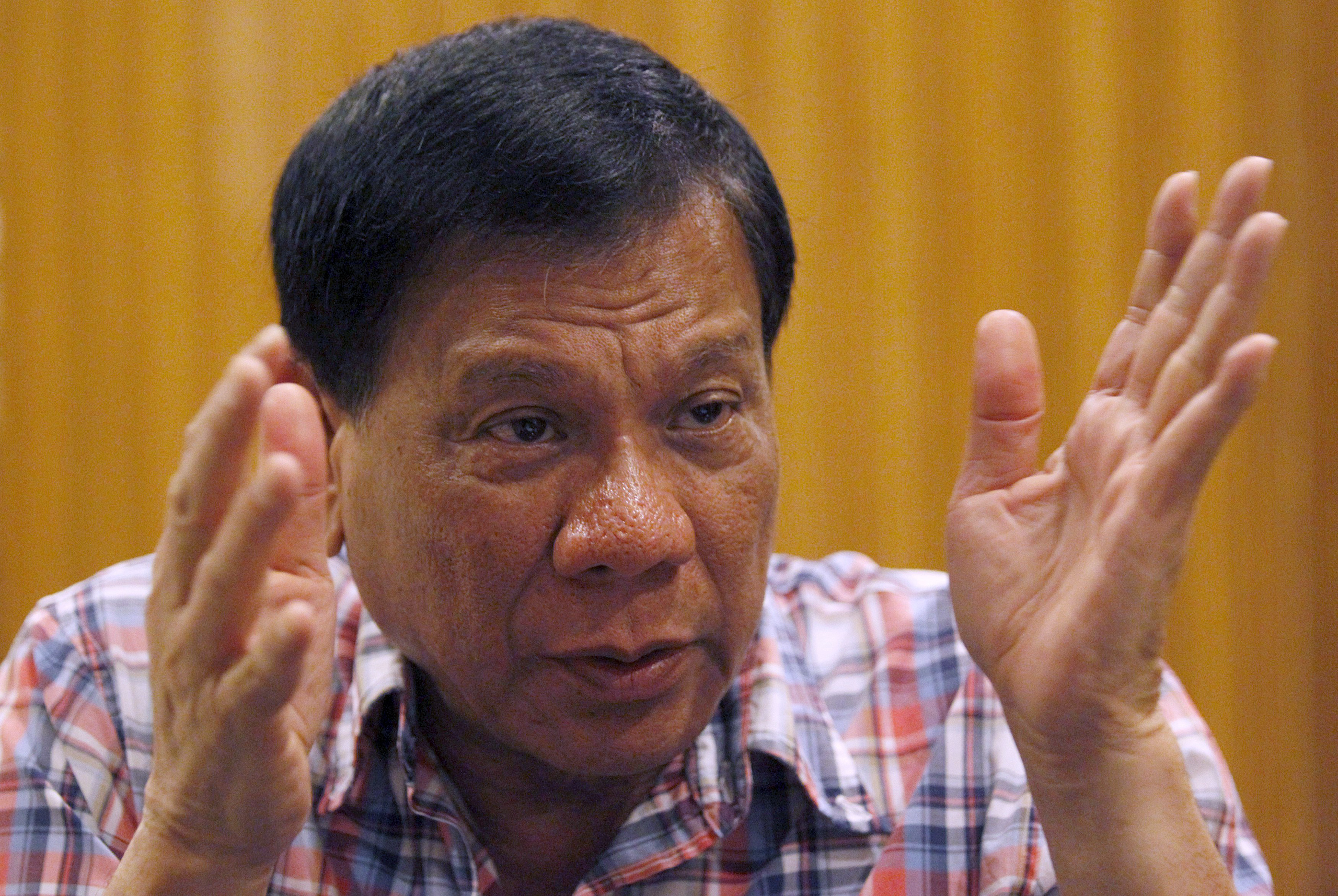 Rodrigo Duterte, the seven-term mayor of Davao City who has built a reputation for fighting crime in the insurgency-plagued south, gestures during an interview in Manila on Dec. 10, 2015 (Czar Dancel—Reuters)
