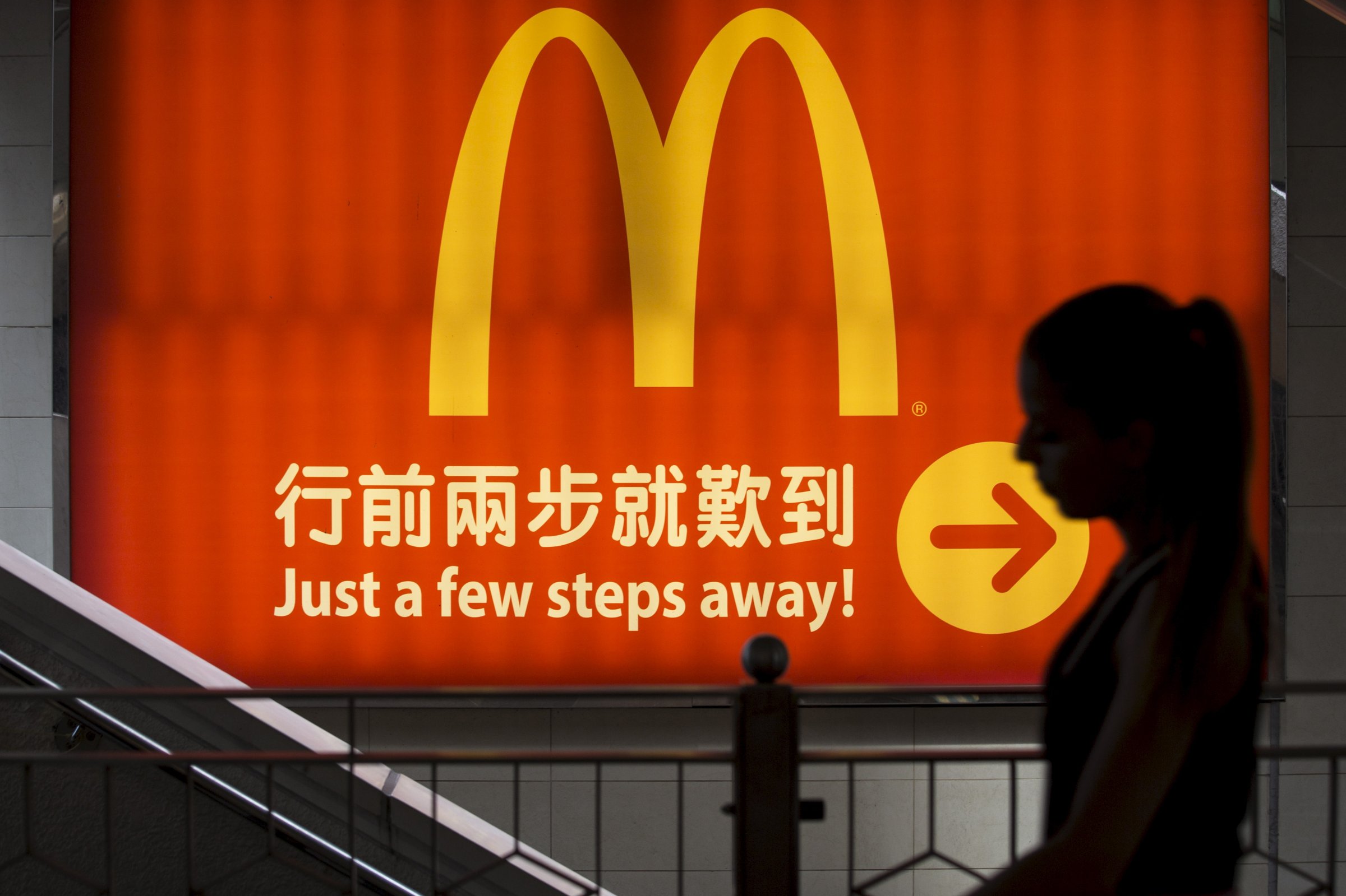File photo of a woman walking past a McDonald's outlet in Hong Kong