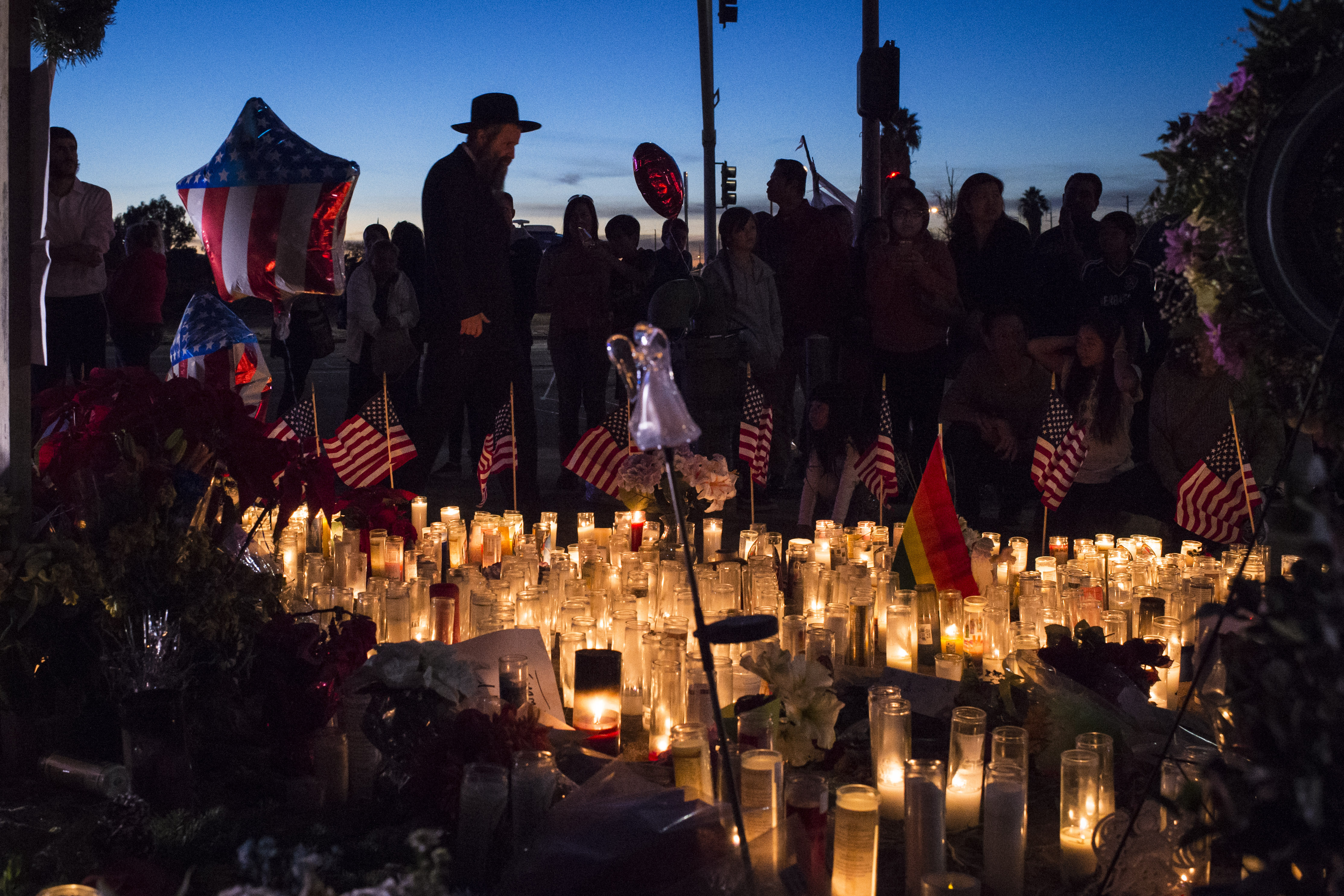 People pay their respects near the location of the mass shooting in San Bernardino, CA, on Dec. 6, 2015. (Jabin Botsford—The Washington Post/Getty Images)
